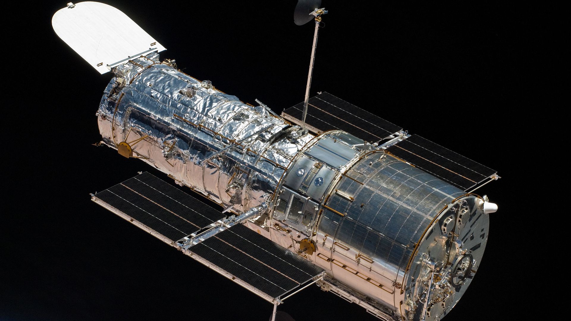 The Hubble Space Telescope shining in silver seen from orbit
