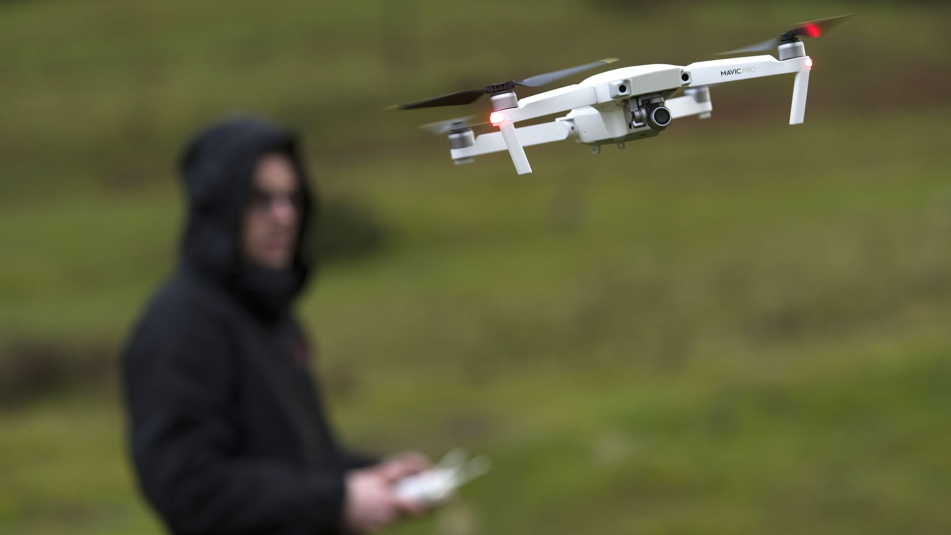 A man flying a drone.
