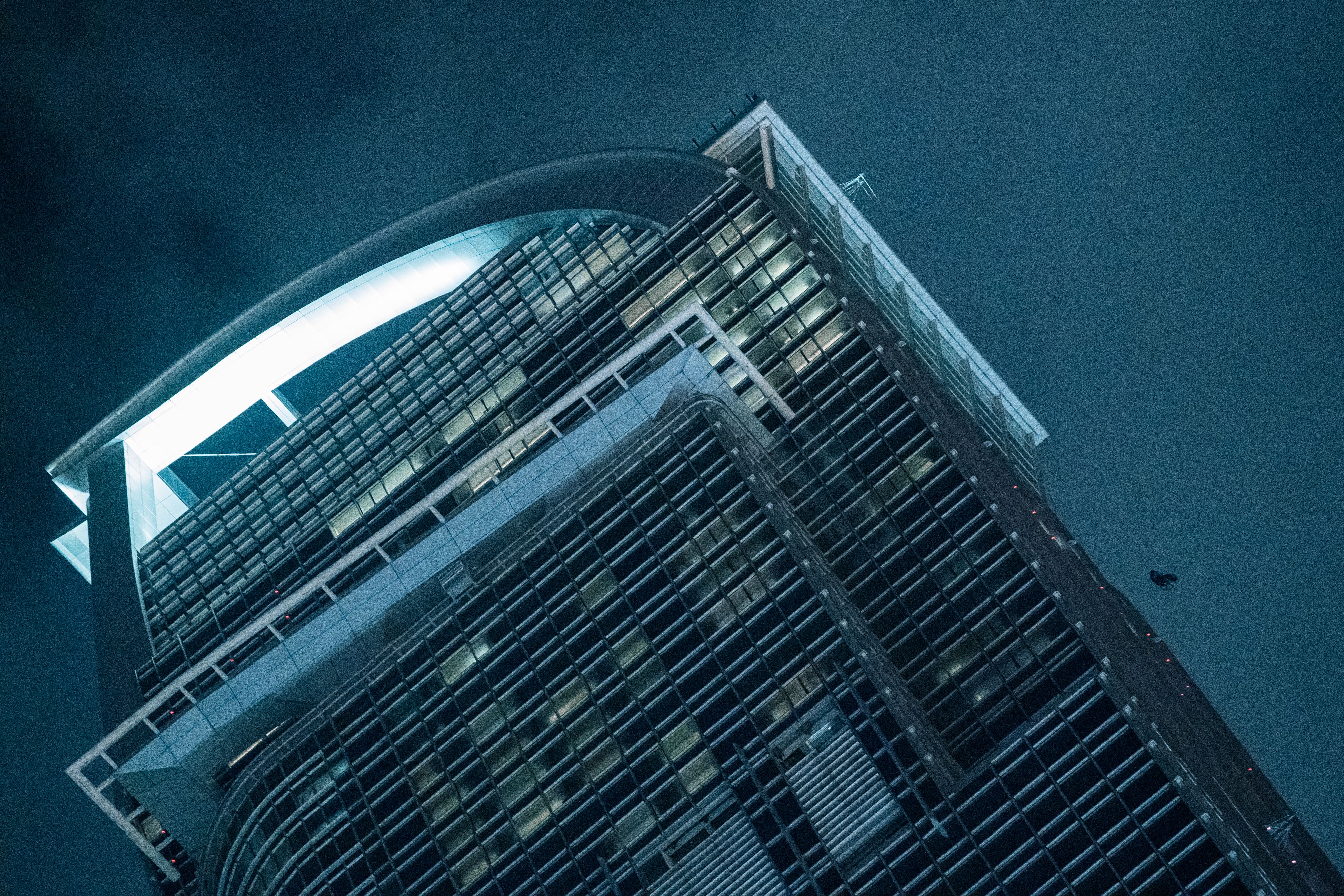 Guy climbing up building