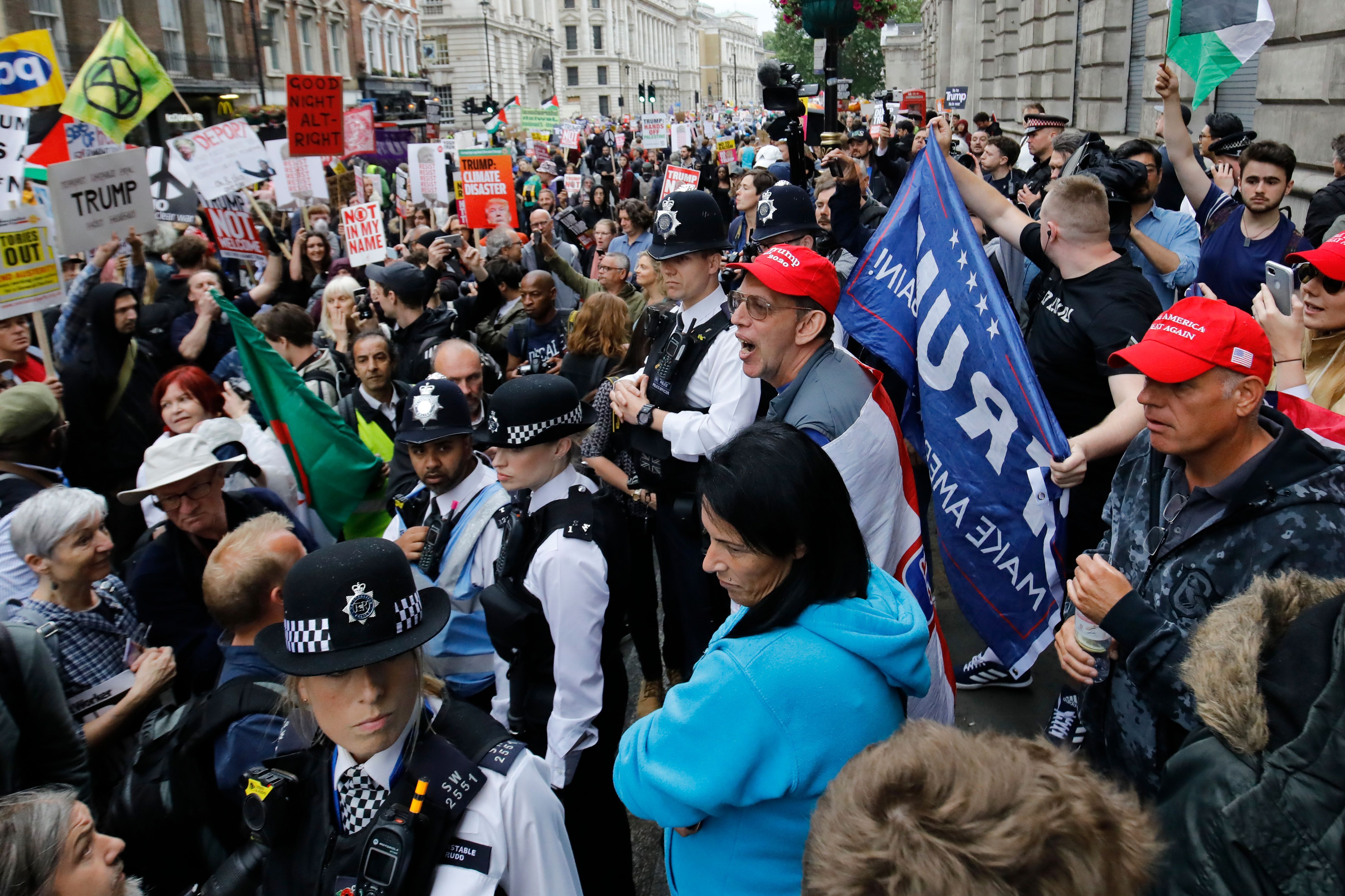 Police form a barrier between pro and anti-Trump protestors along whitehall in London on June 4, 2019.