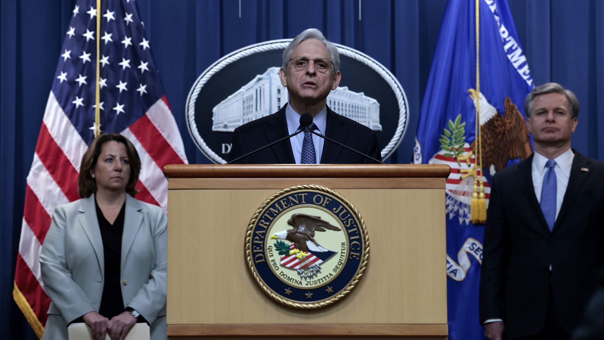 Attorney General Merrick Garland in front of Deputy U.S. Attorney General Lisa Monaco and FBI Director Christopher Wray at the Justice Department on April 6.
