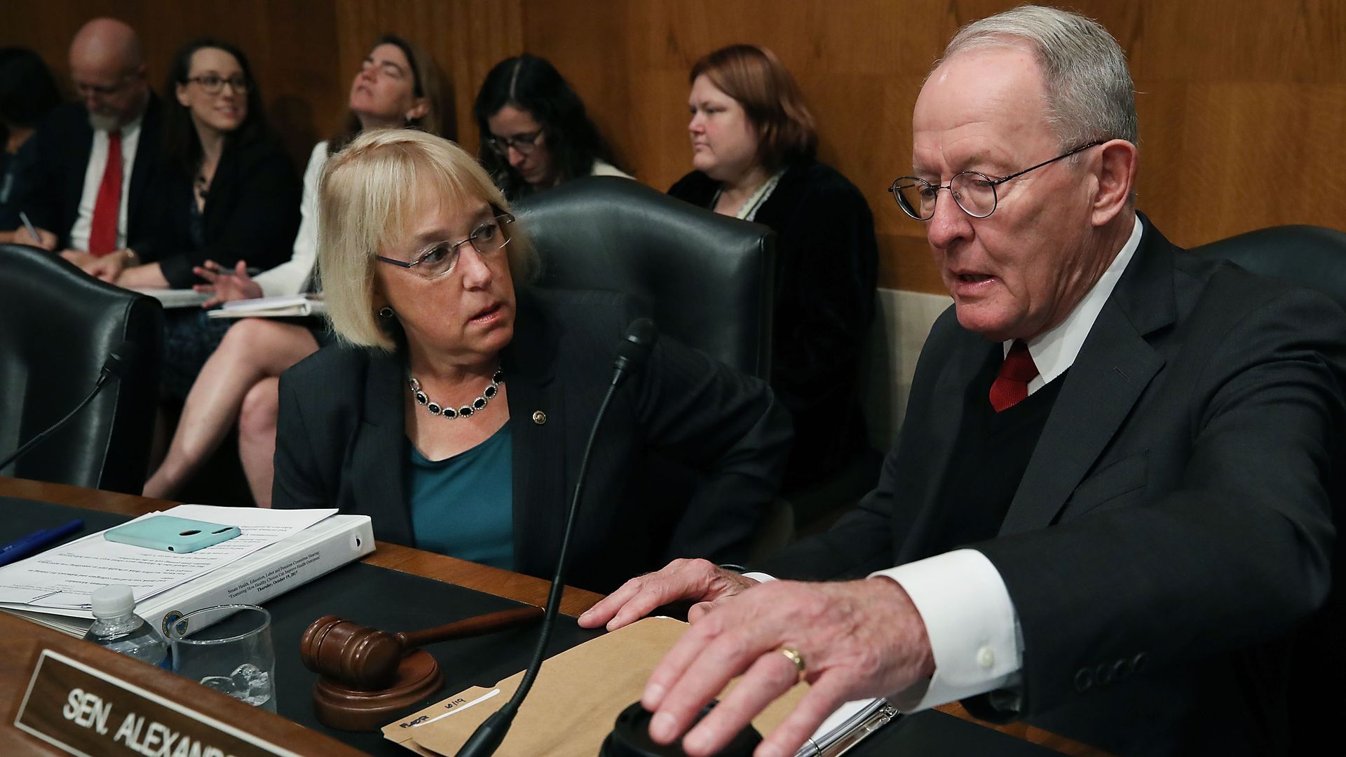 In this image, Sens. Murray and Alexander talk while one reaches for coffee.