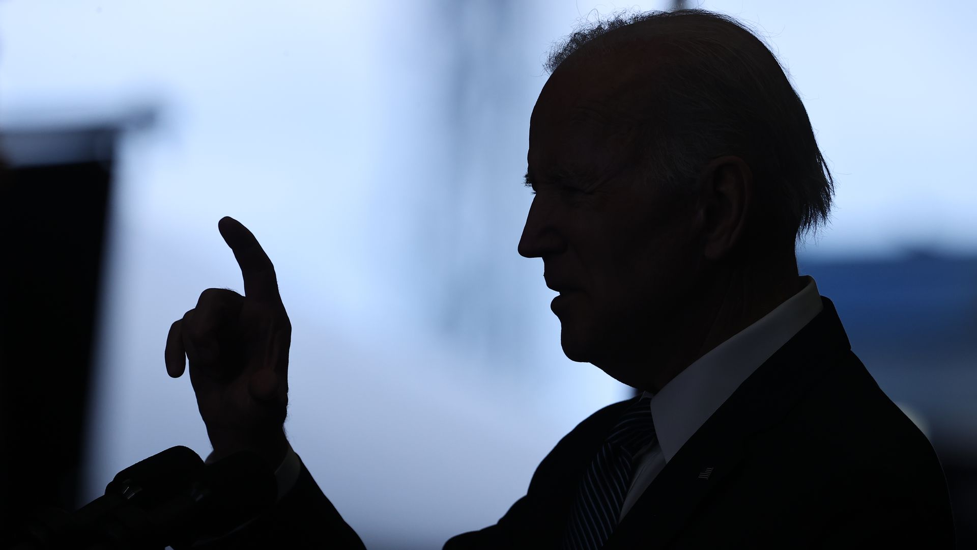 President Biden is seen speaking in silhouette while visiting Portsmouth, N.H., on Tuesday.