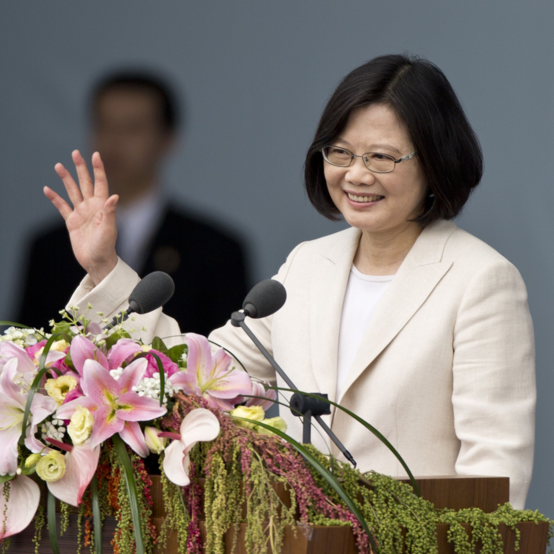 Taiwanese president Tsai Ing-wen waving from behind a lectern