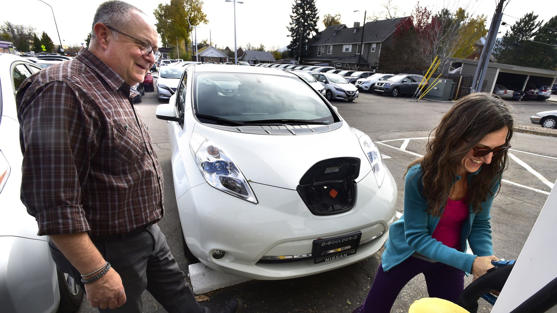 Shanna Solla laughs as she learns how to use the electric charging station in 2018. 