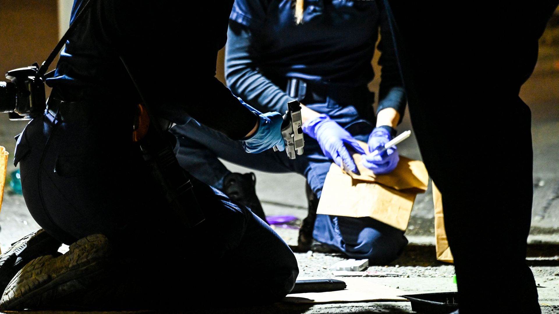 Photo shows crime scene investigators after a shooting at a Mardi Gras parade