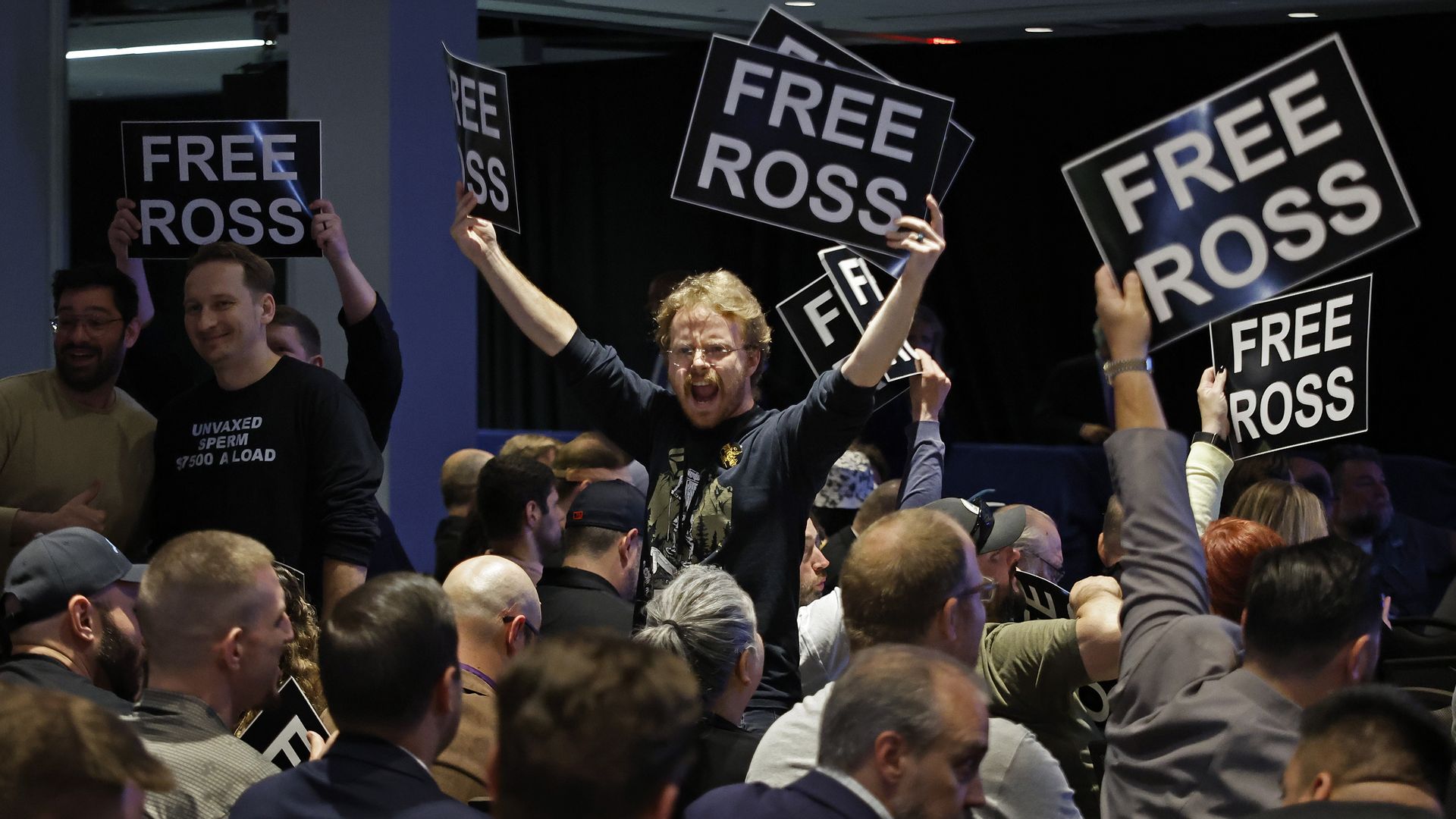 Libertarian National Convention attendees hold "Free Ross" signs