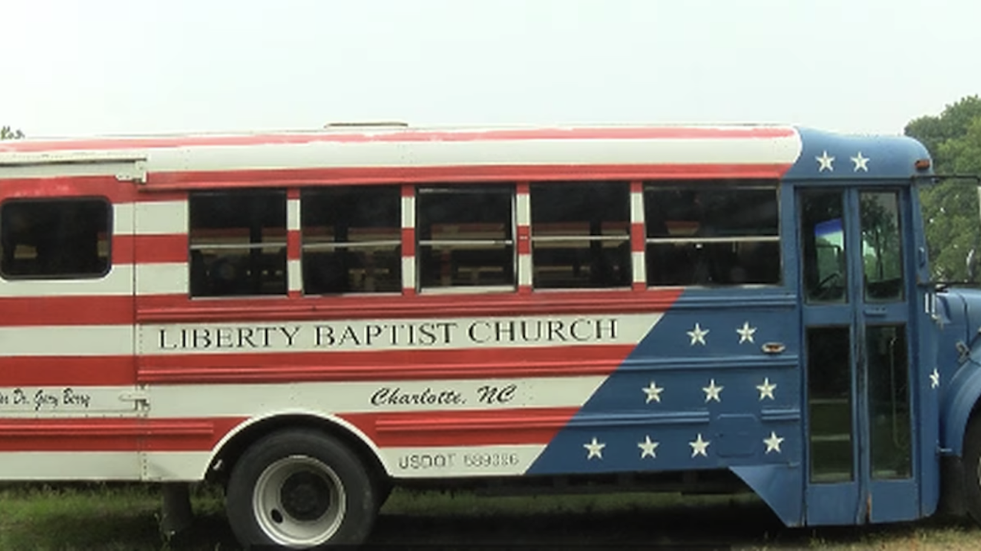 school bus painted red, white and blue like the American Flag
