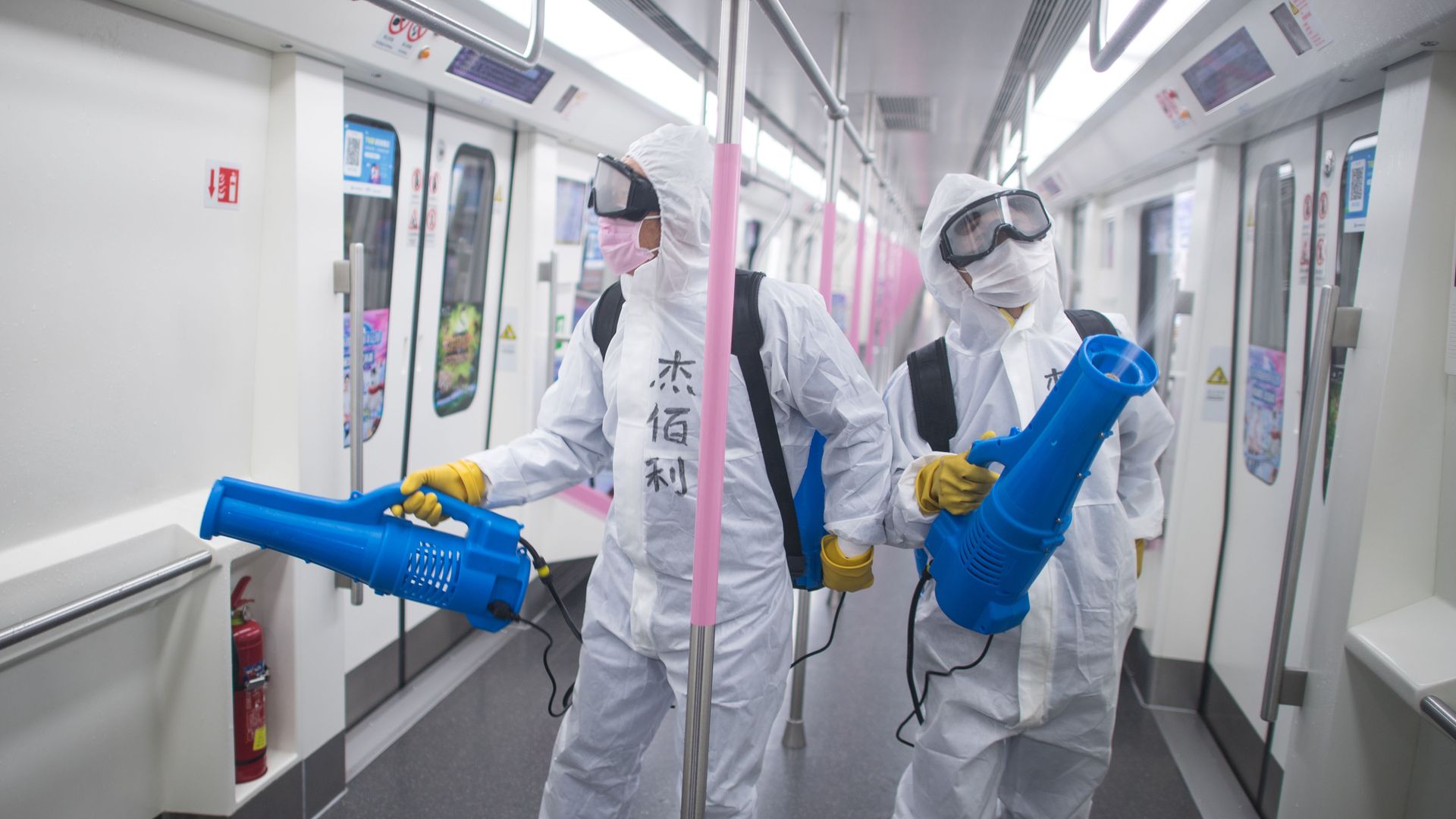 Staff members conduct disinfection on the subway train at a train depot in Wuhan, central China's Hubei Province, March 23