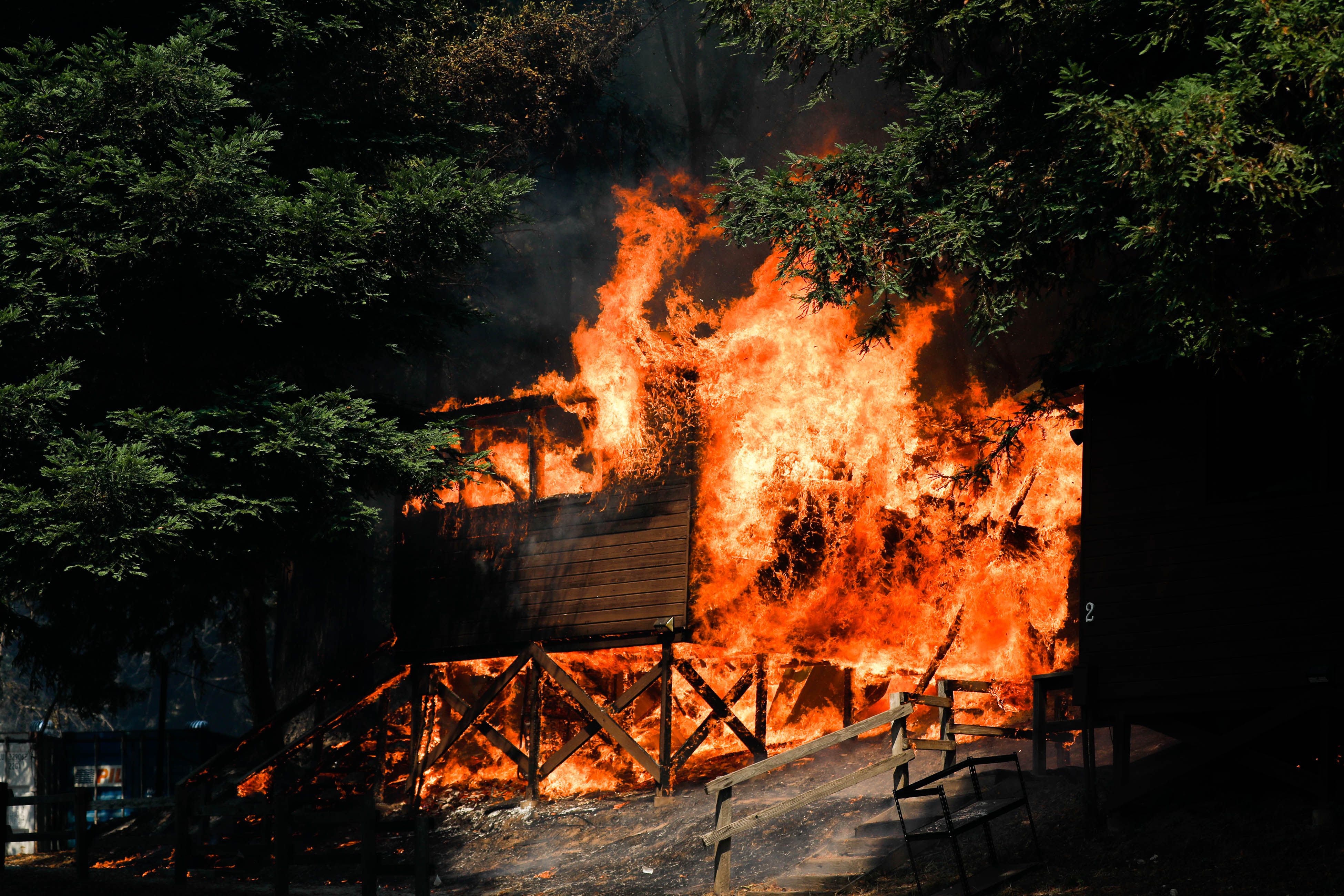 A cabin near Little Basin Road and Highway 236 goes up in flames in Boulder Creek, Calif.
