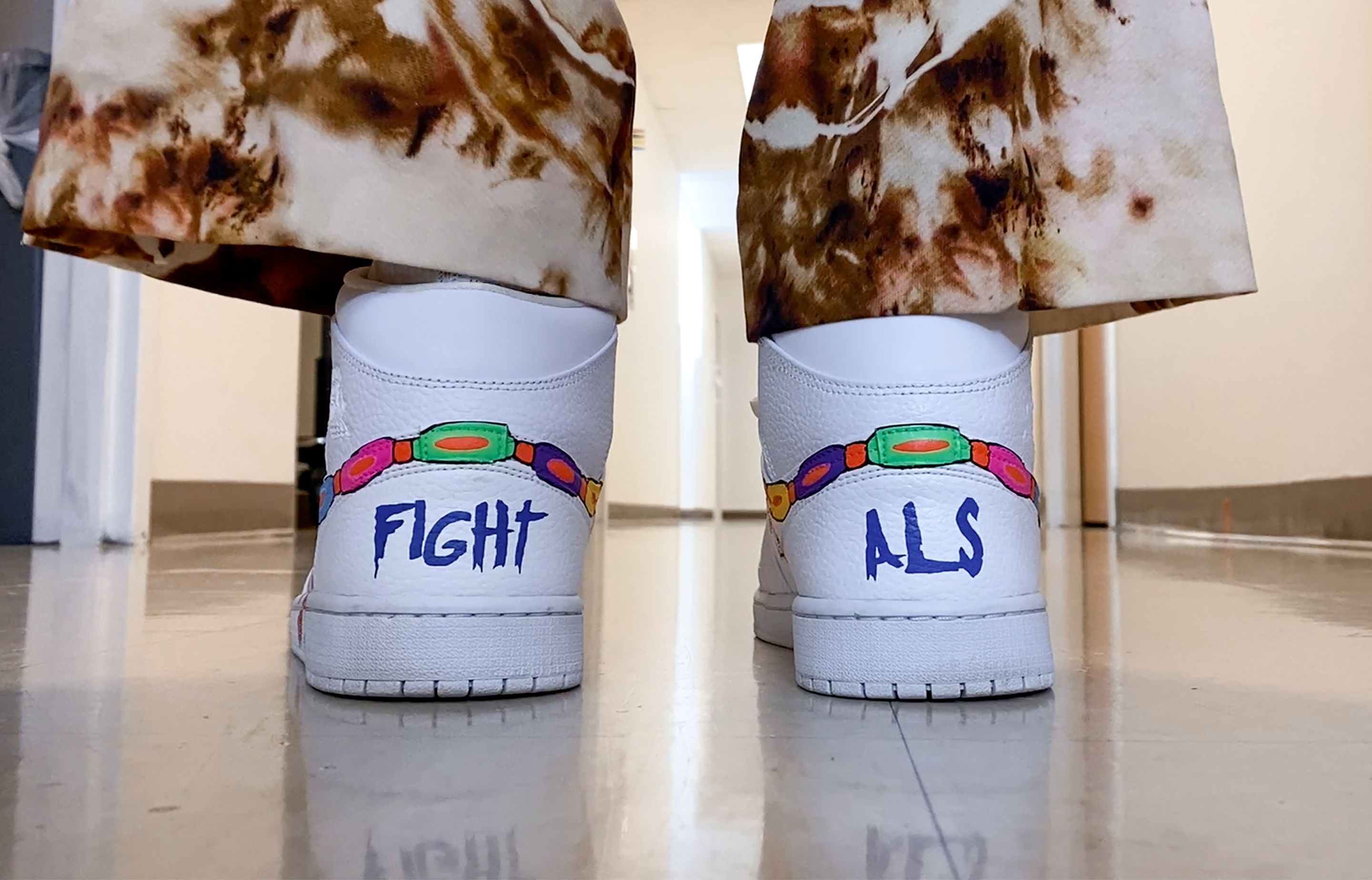 Sneakers that have "Fight ALS" written on them