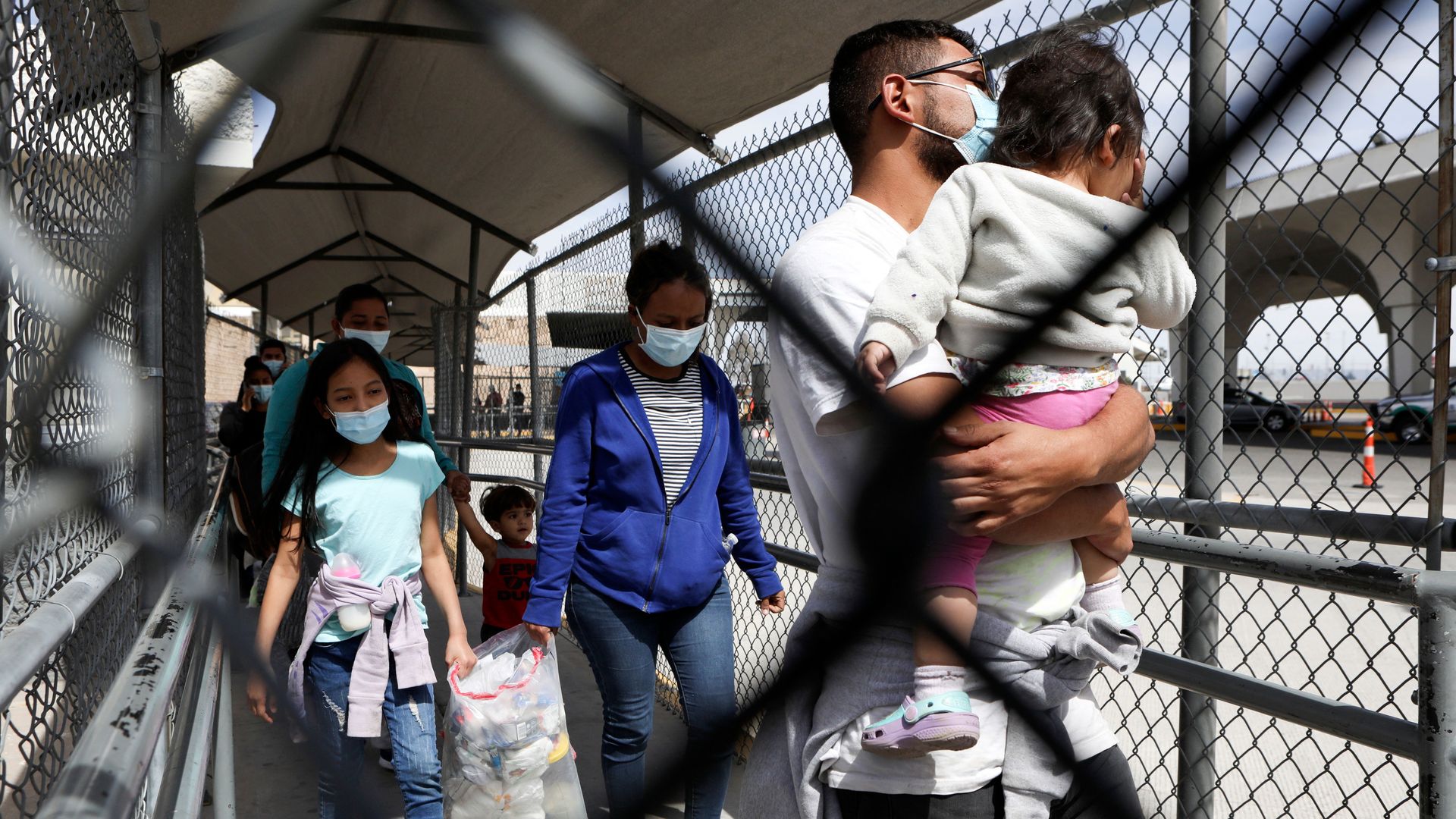 Central American migrants walk along the Stanton international bridge from El Paso, Texas to Ciudad Juarez, Chihuahua state, Mexico, Getty Images)