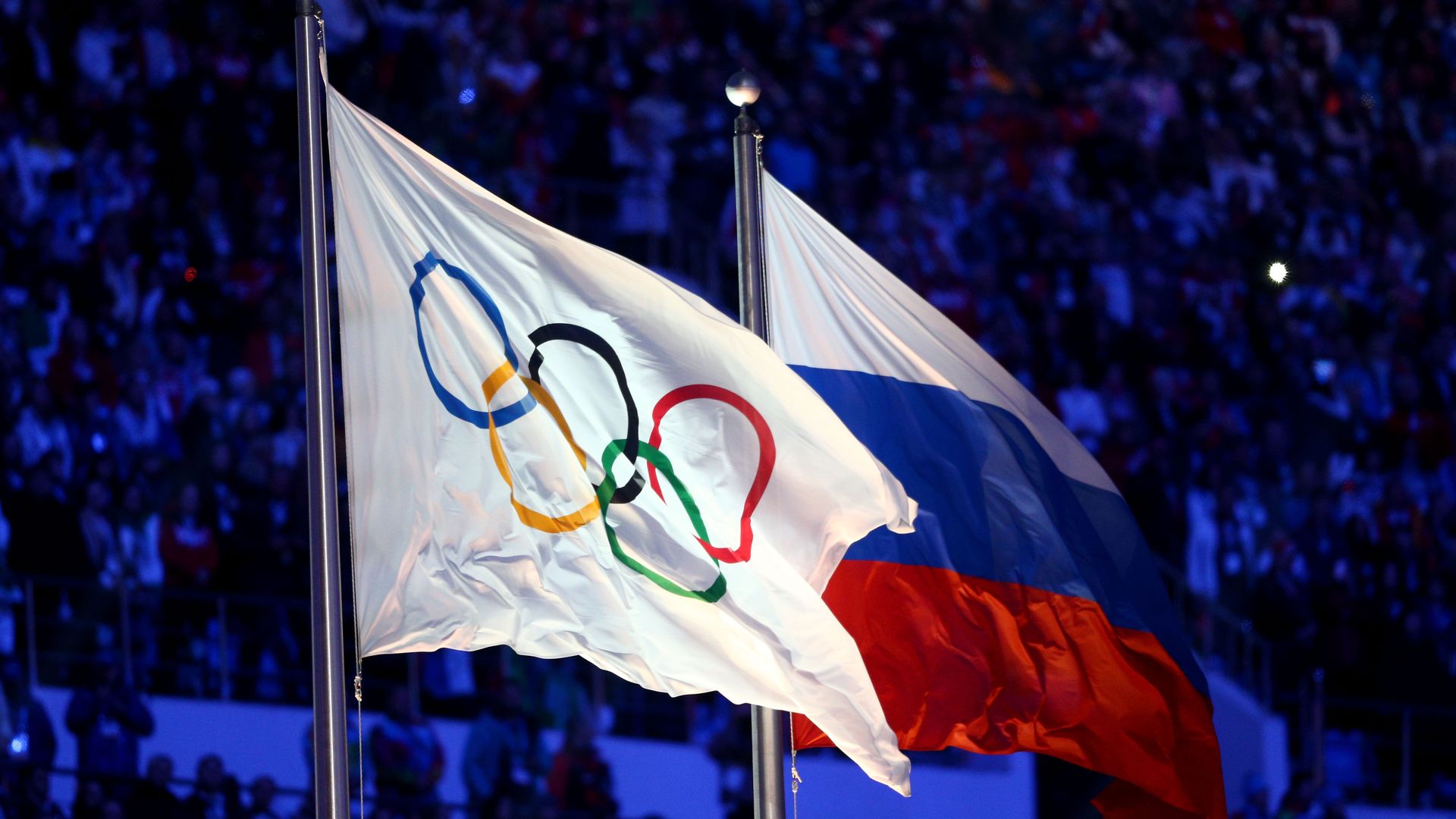 The Olympic flag and Russian flag during the 2014 Sochi Winter Olympics.