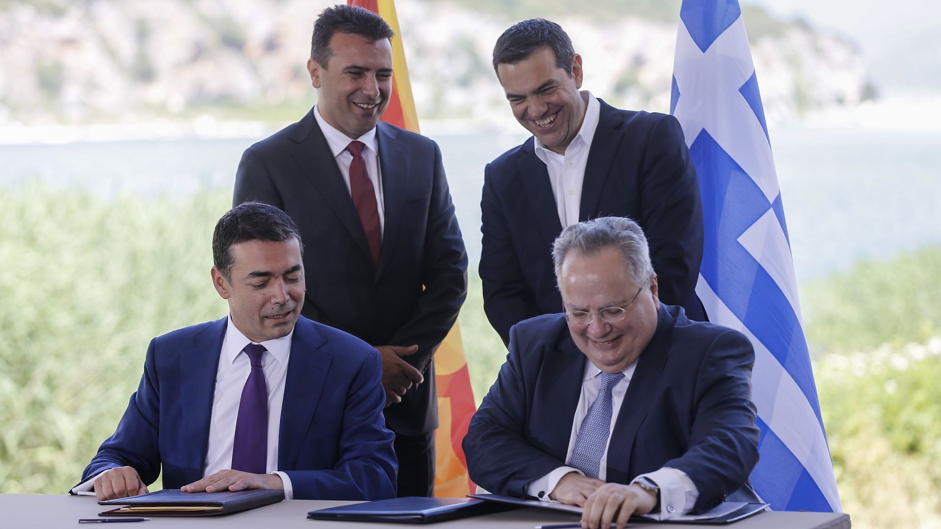 Greek Prime Minister Alexis Tsipras (back R) and Macedonian Prime Minister Zoran Zaev (back L) during the signing ceremony on Sunday.