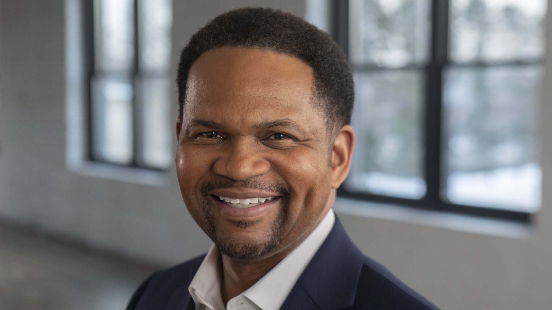 A photo of a man smiling.