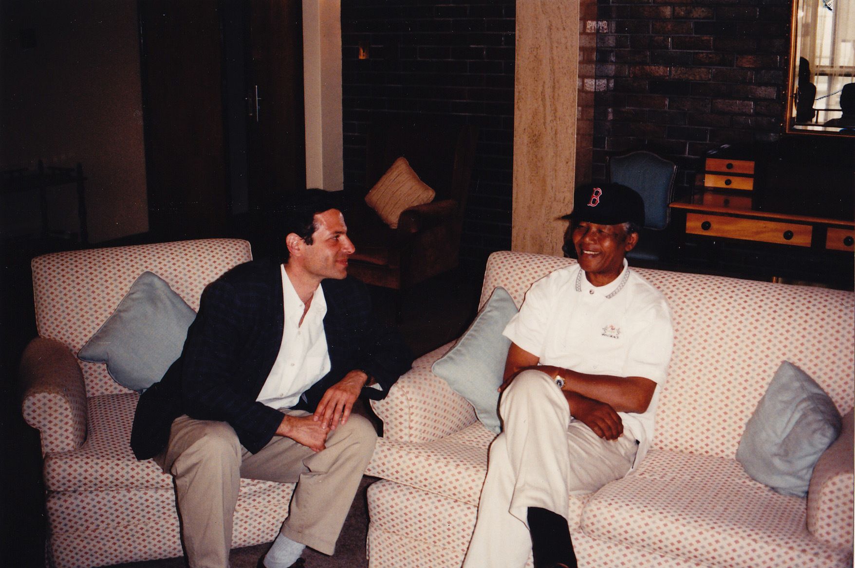 Richard Stengel amd Nelson Mandela wearing a Red Sox cap.