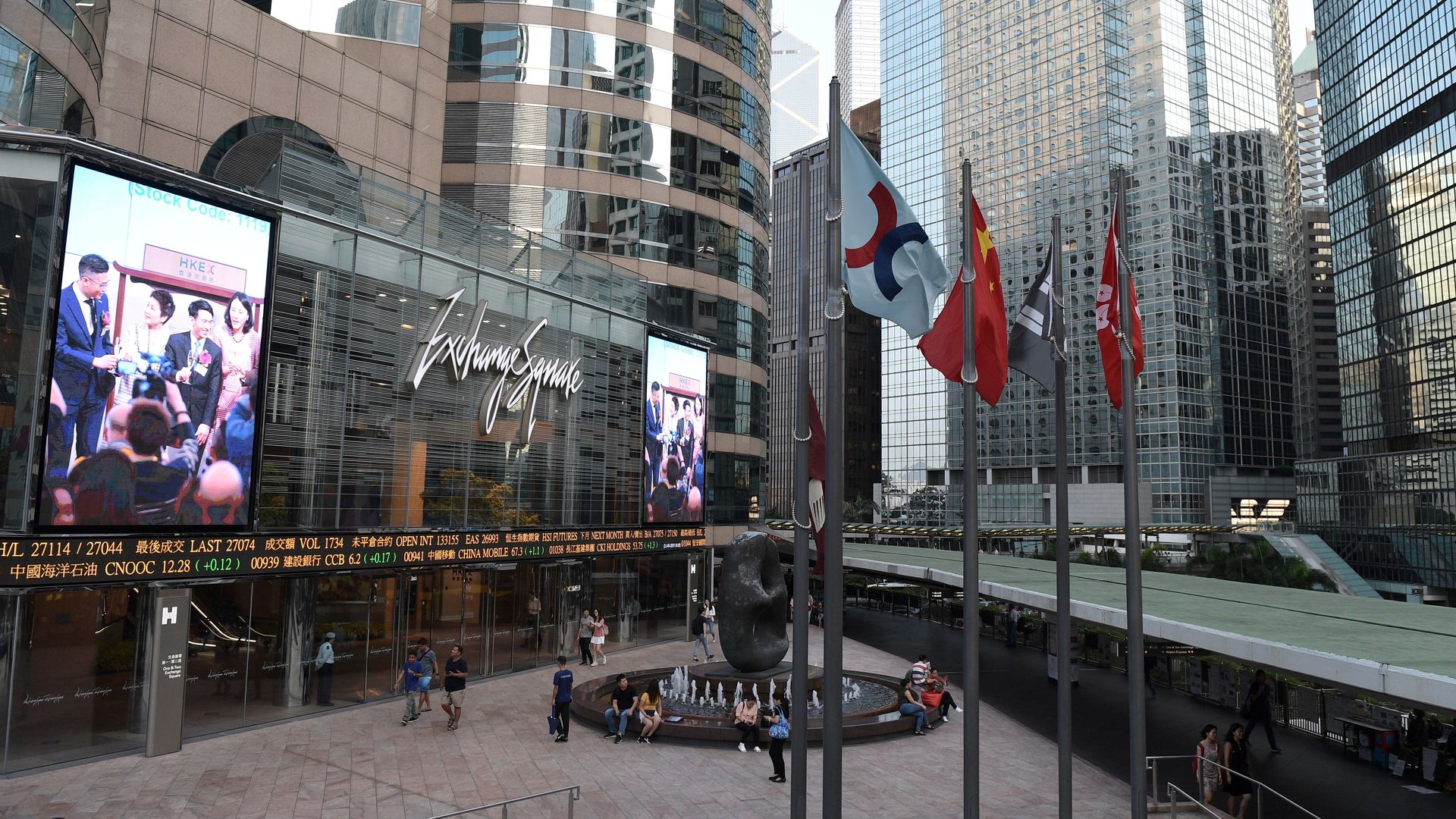 A view of the Hong Kong Stock Exchange flag (C) next to the Chinese national flag (2nd L) and the Hong Kong SAR flag (R), outside the exchange offices in Hong Kong.