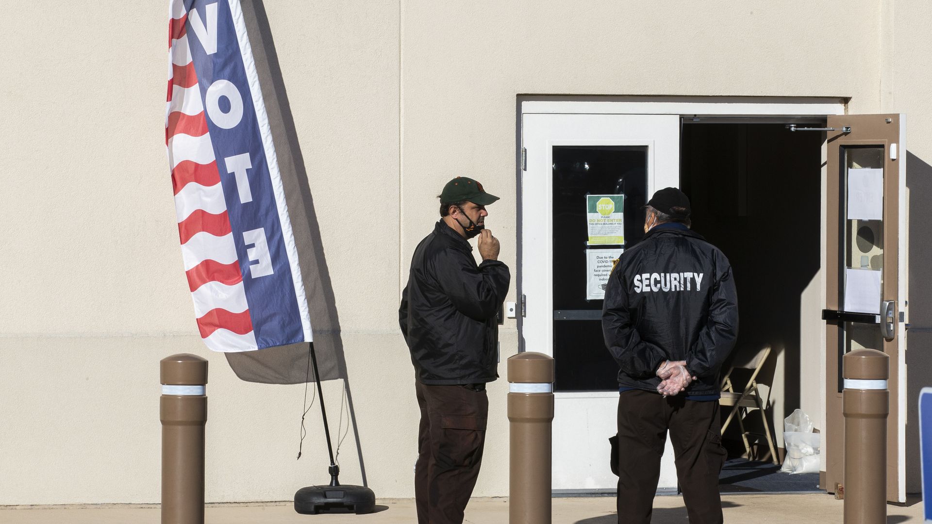  Hired security personnel wait for voters outside the Leon County Supervisor of Elections office on November 3, 2020