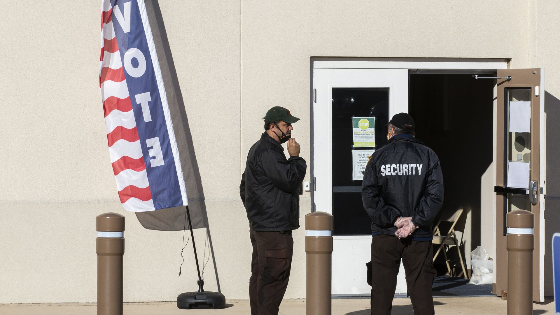 Hired security personnel wait for voters outside the Leon County Supervisor of Elections office on November 3, 2020