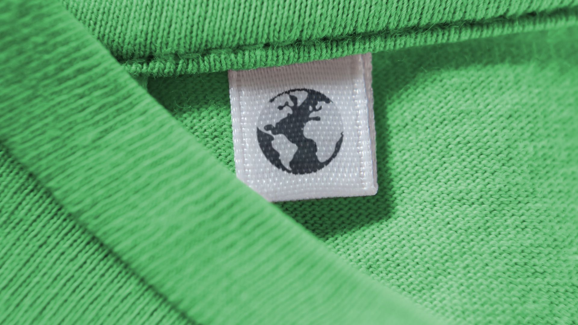 Illustration of a shirt tag printed with an Earth icon