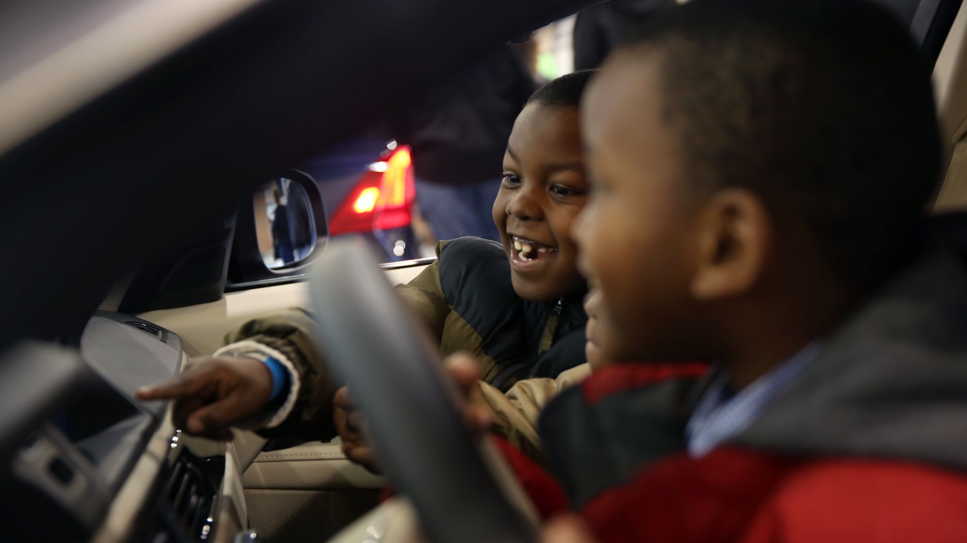 Children playing inside a vehicle at the Philadelphia Auto Show