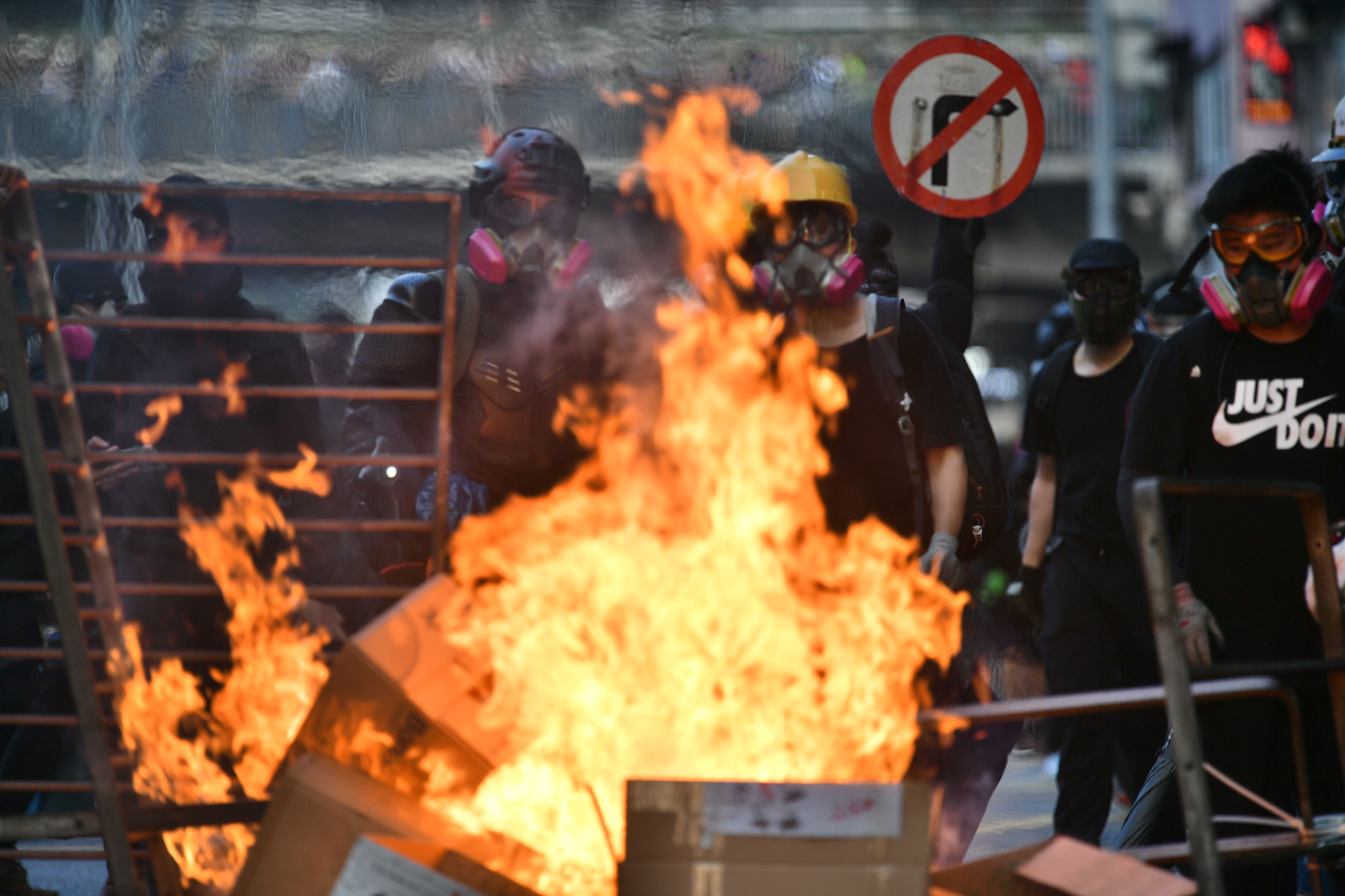 Protesters at burning barricade.