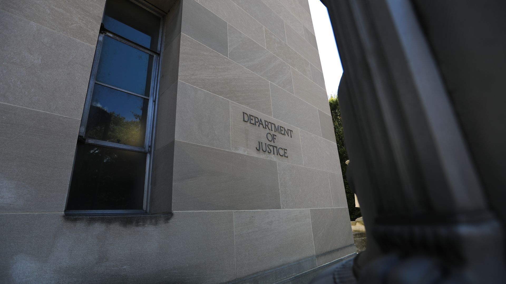 Photo of the U.S. Department of Justice building, with "Department of Justice" inscribed on the outer wall