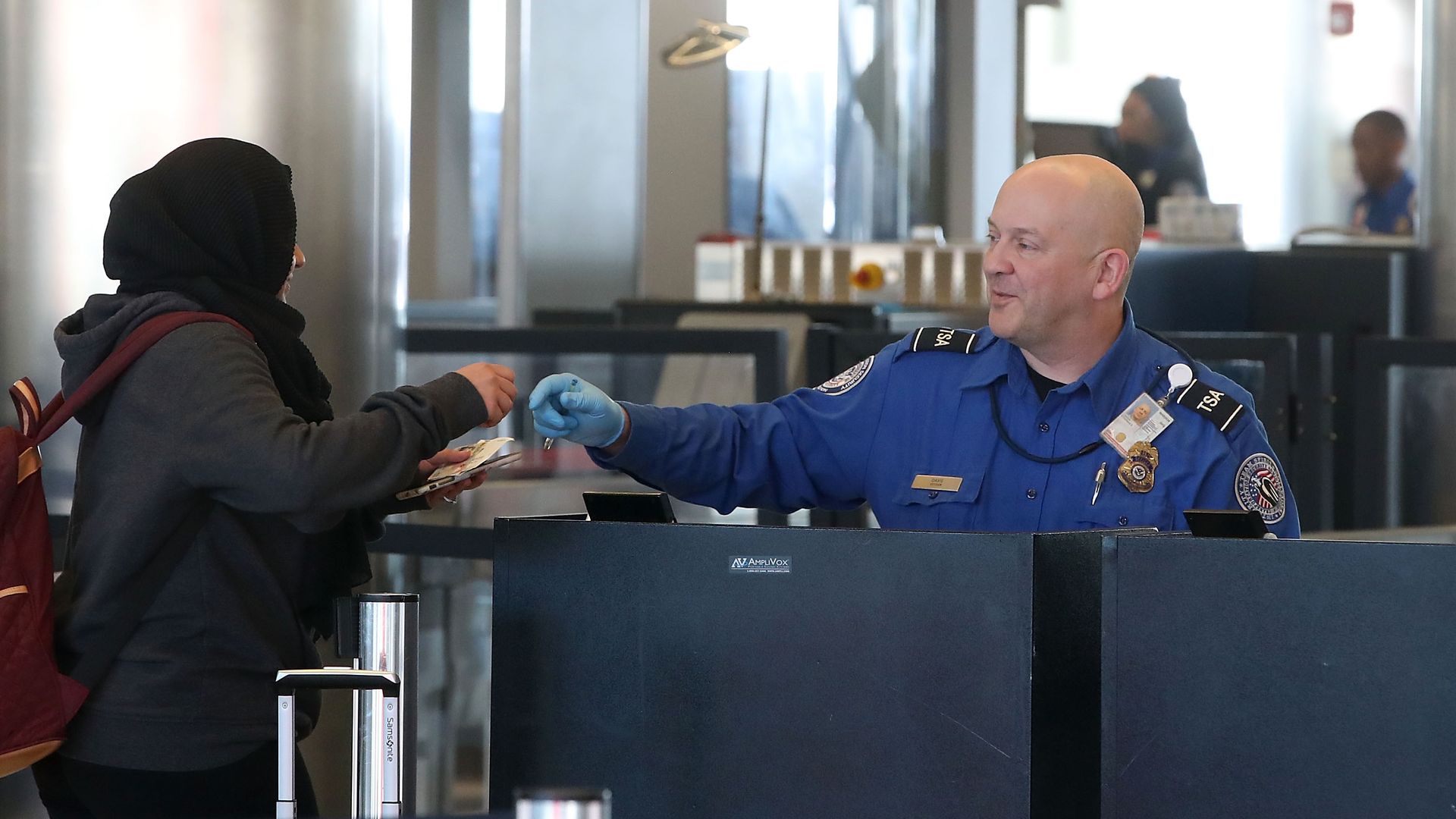 TSA officer checking boarding passes