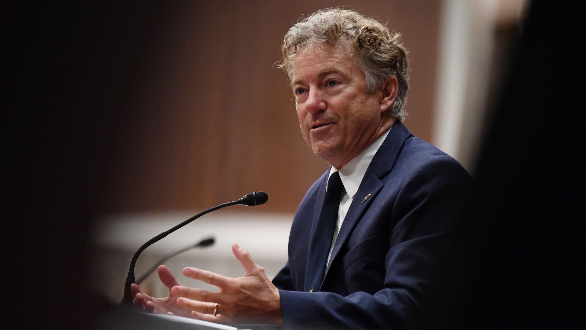 Rand Paul speaks in front of a microphone