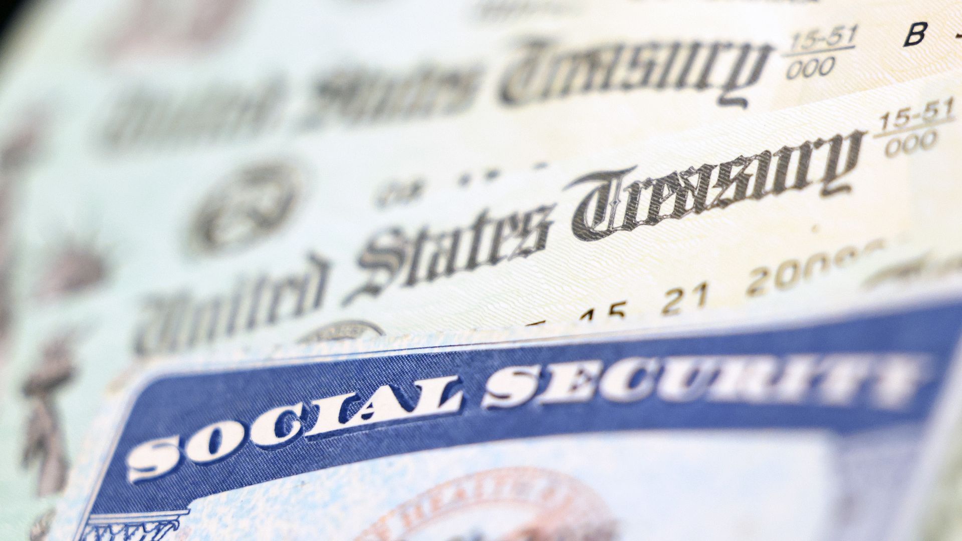 Social Security card on top of checks from United States Treasury