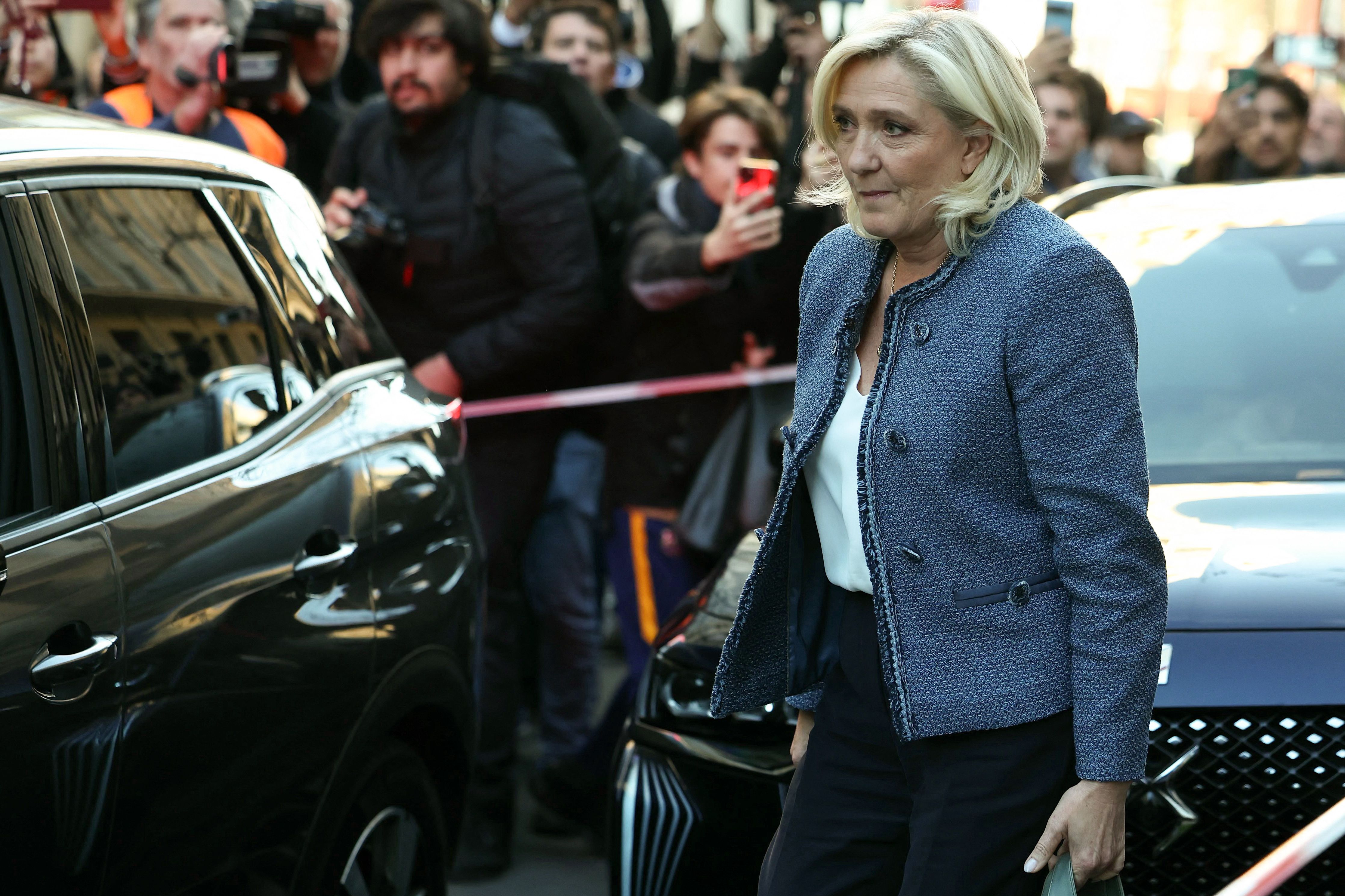 President of the parliamentary group of the French far-right Rassemblement National (RN) party, Marine Le Pen leaves the headquarters of the French far-right Rassemblement National (RN) party, after a French court sentenced her to a five-year ban on running for office and a prison term in a trial on
