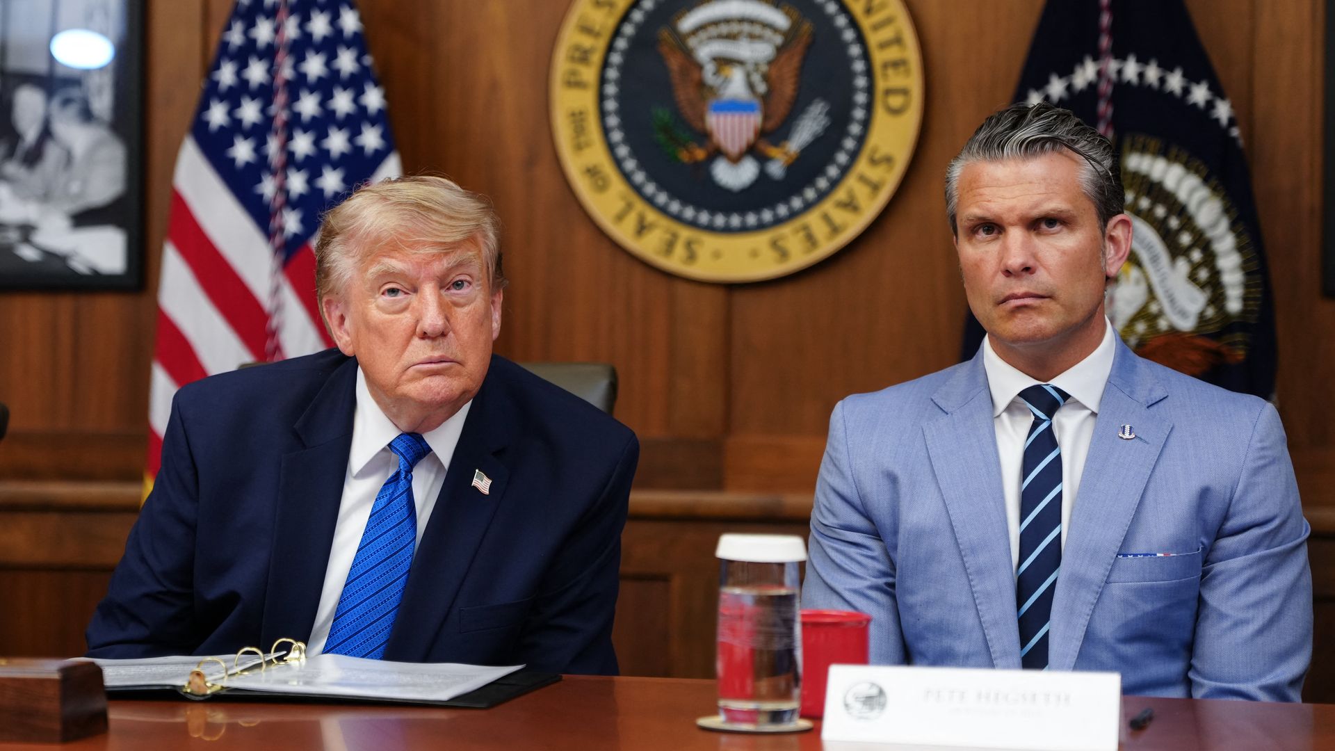 President Trump sits beside Secretary of War Pete Hegseth during a Cabinet meeting at Camp David.