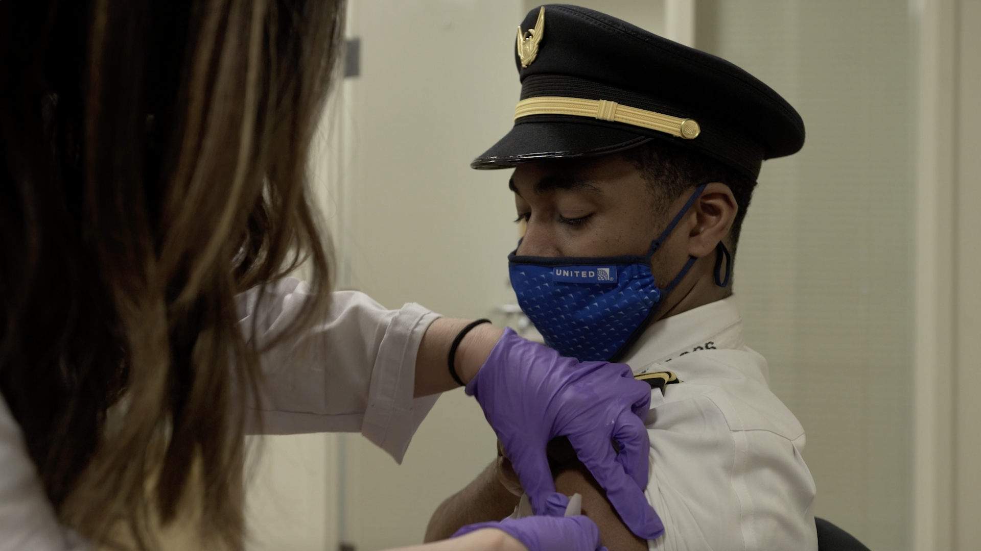 A United Airlines pilot receives the COVID shot. 