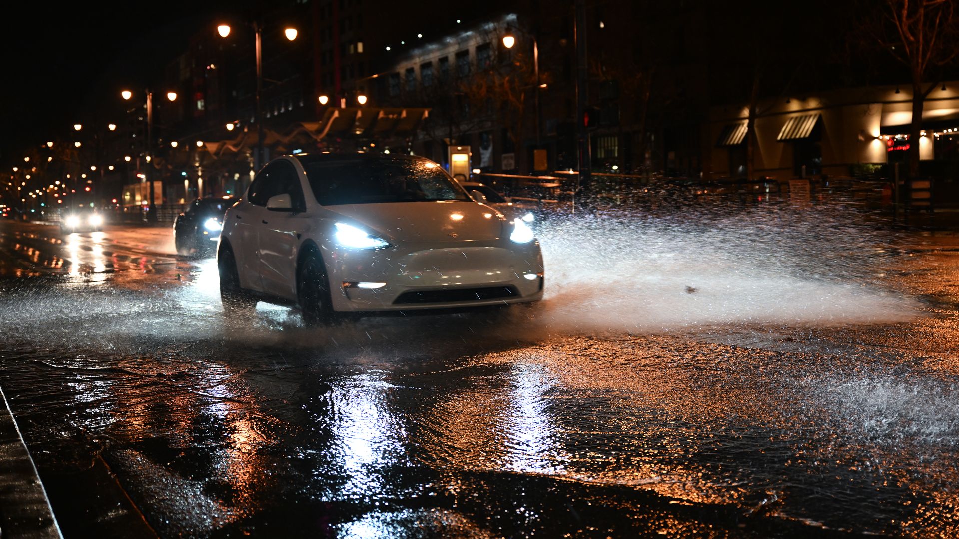 tesla drives through a flood