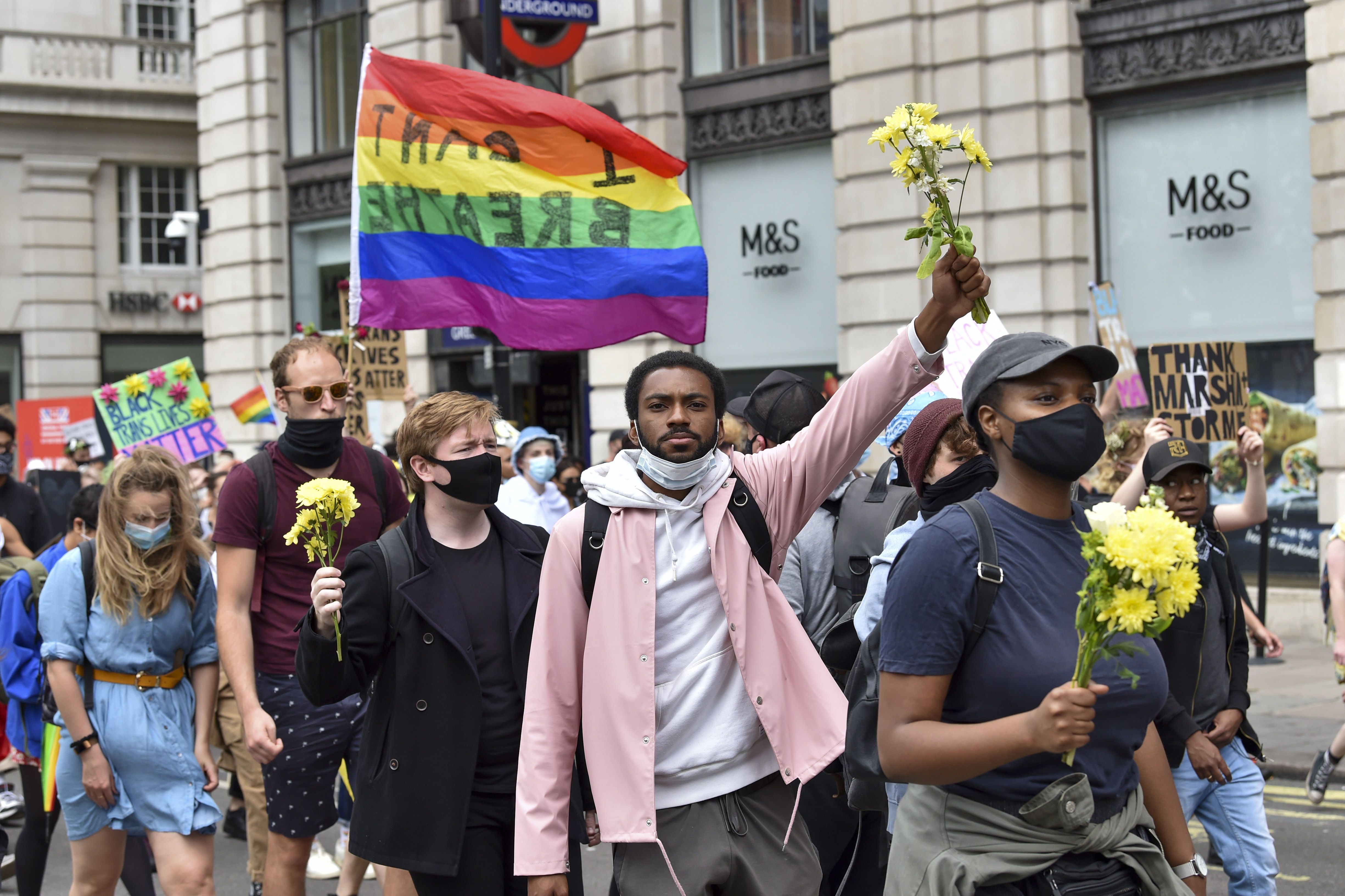 People with flags & flowers at the Black Trans Lives Matters' march in London. 