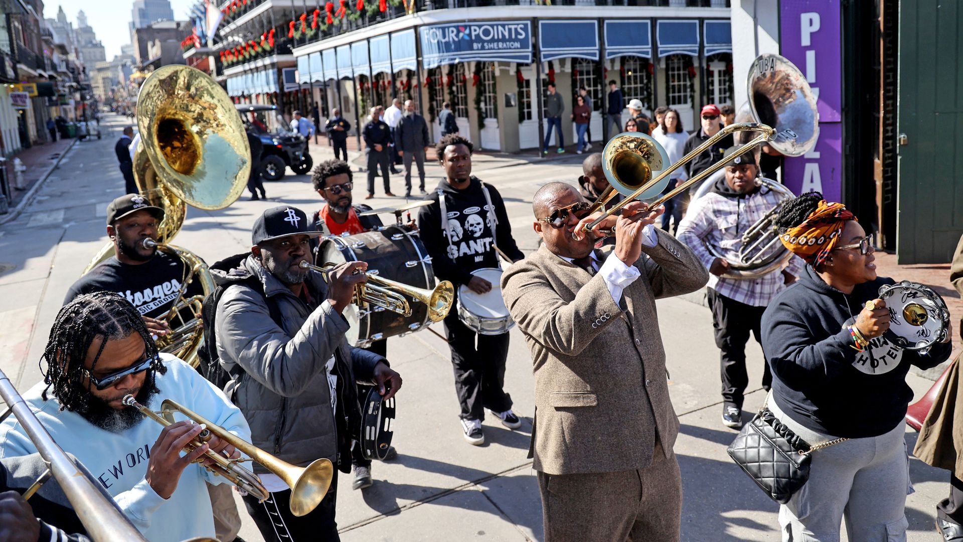A brass band performs as it walks past the Four Points Sheraton in the French Quarter.