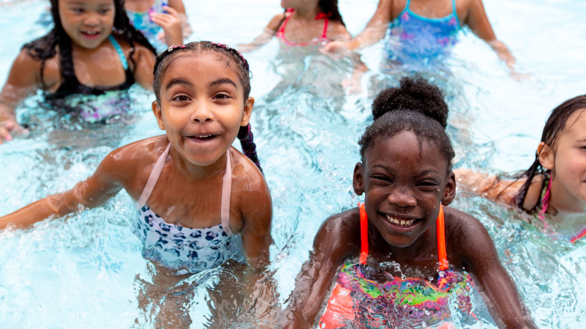 Children playing in a pool. 