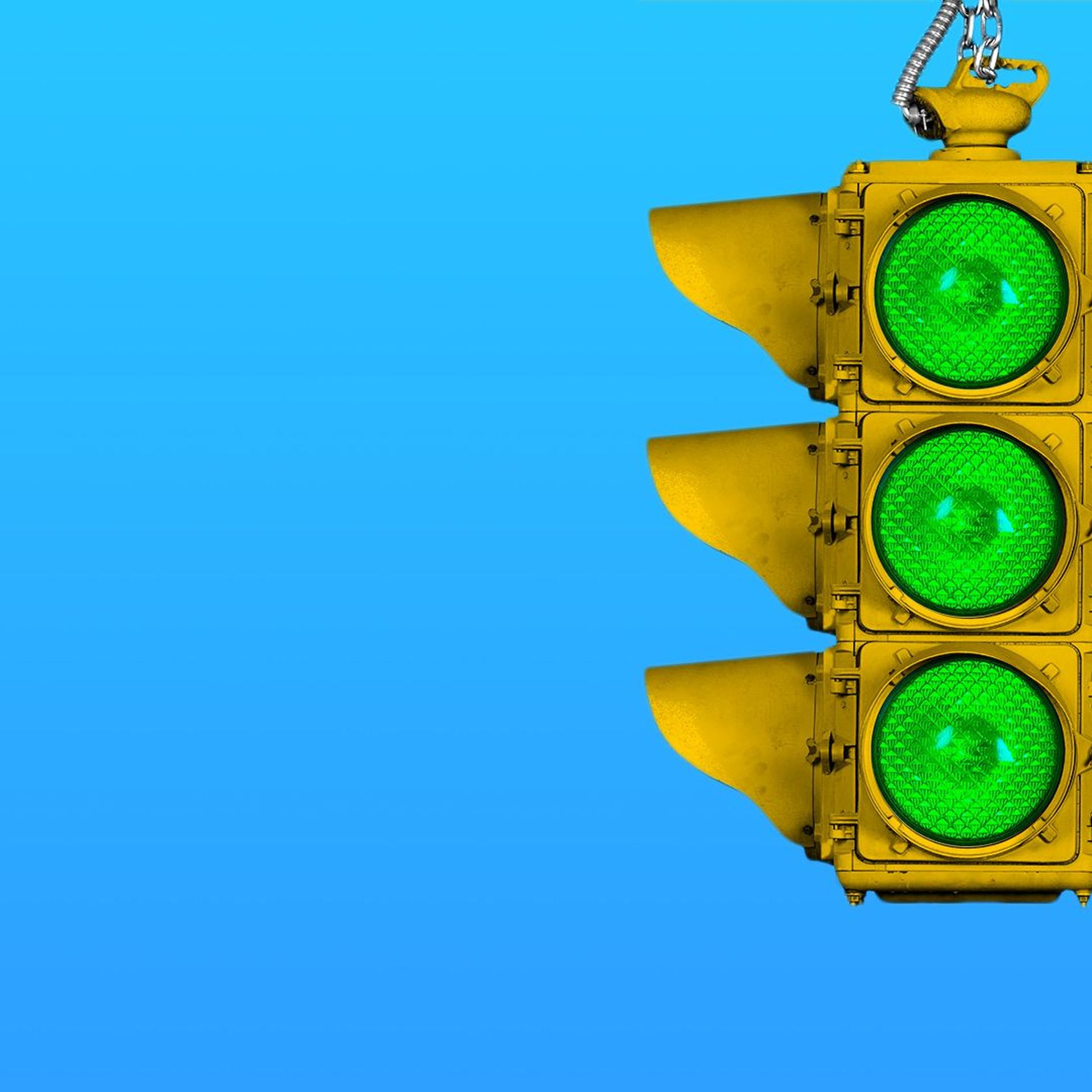 Illustration of a traffic light with three green lights.