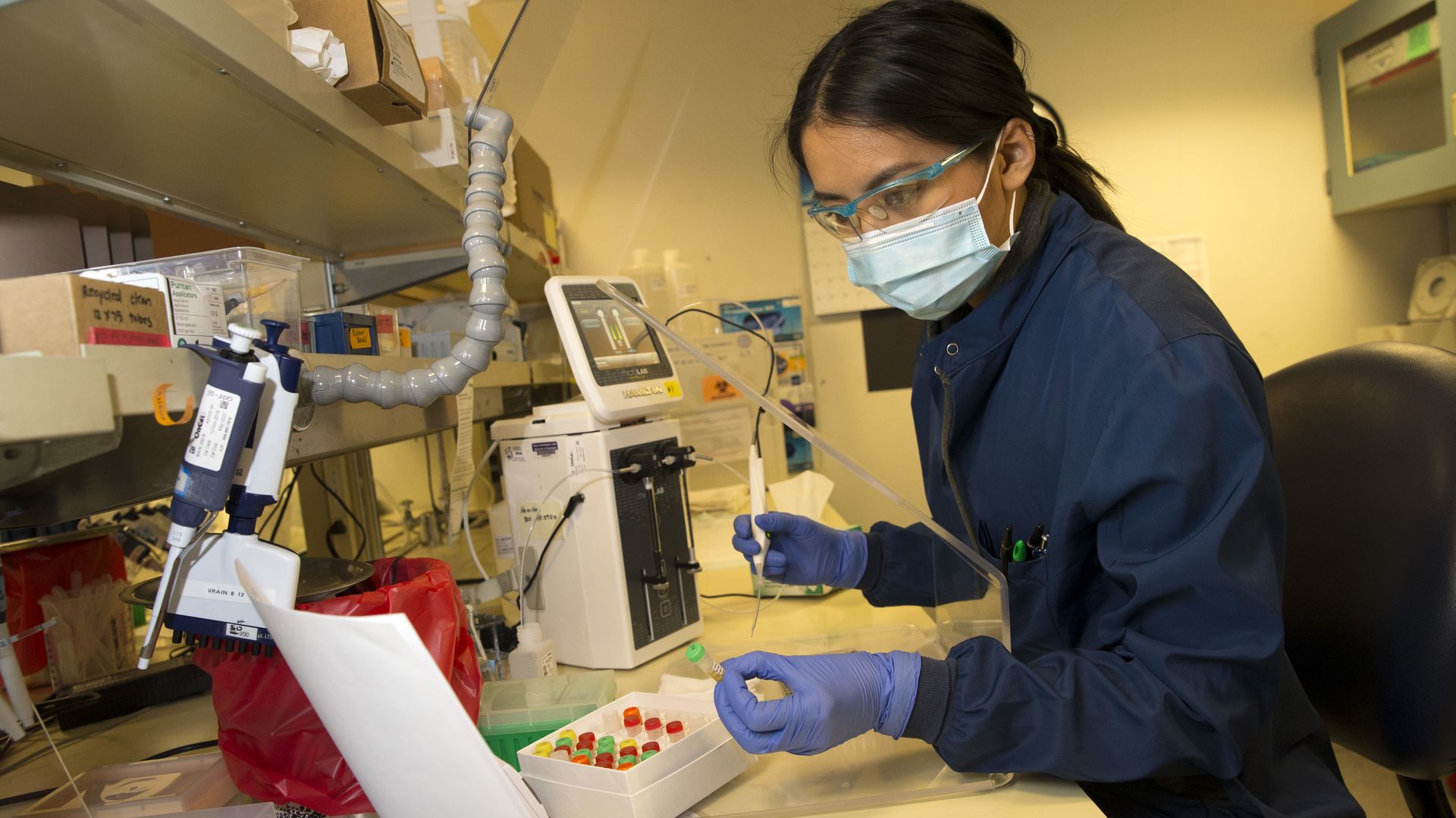 A lab scientist conducts a test for antibodies in the blood of patients who have recovered from the coronavirus