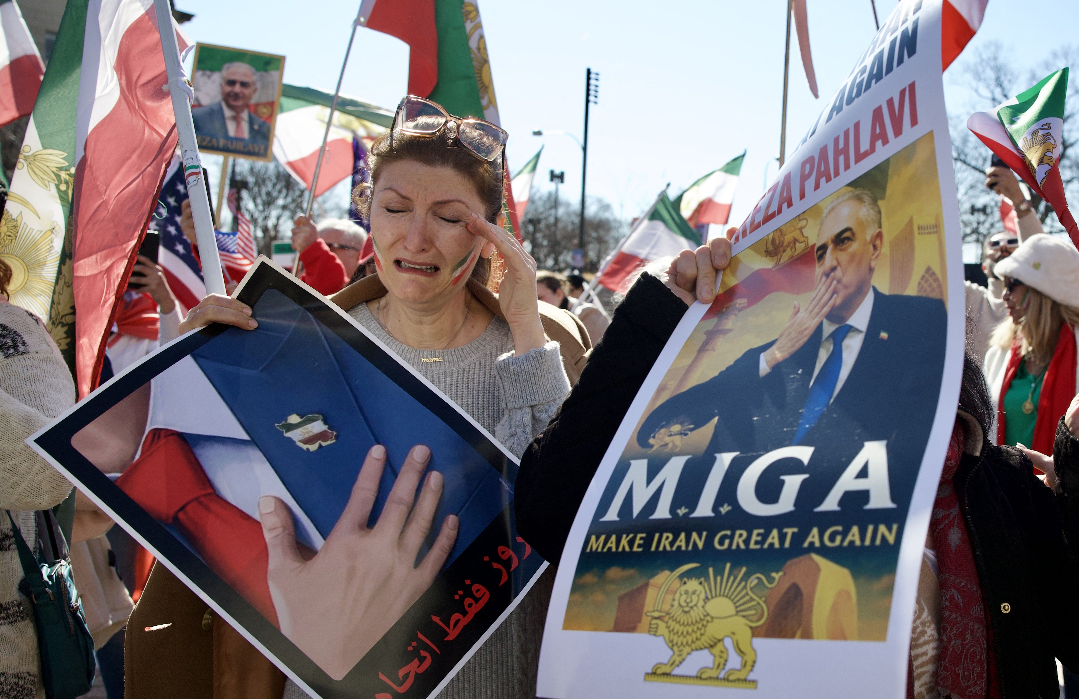 Protesters in D.C. wave Iranian and U.S. flags alongside a photo of Reza Pahlavi — son of the former shah — during a rally in support of U.S. and Israeli strikes in Iran.
