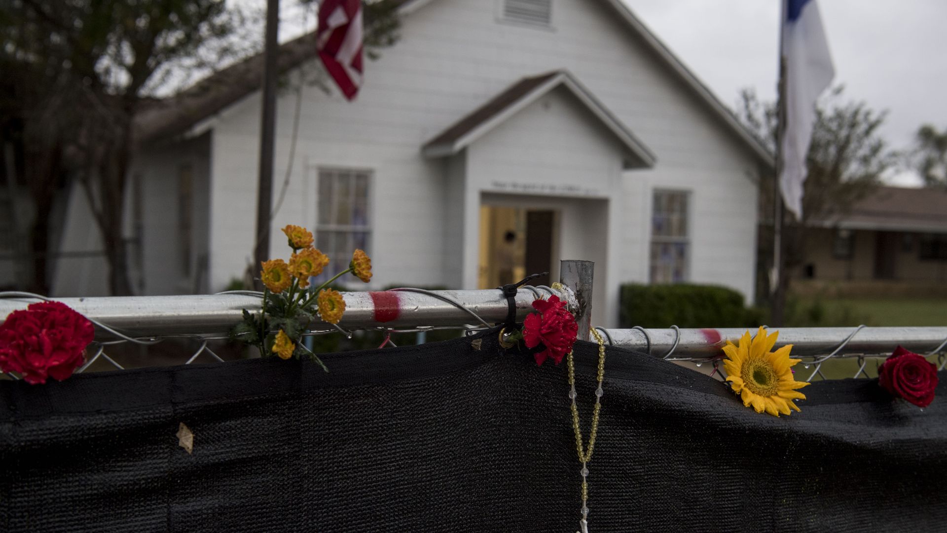 A rosary hangs on the fence outside the Sutherland Springs First Baptist Church.