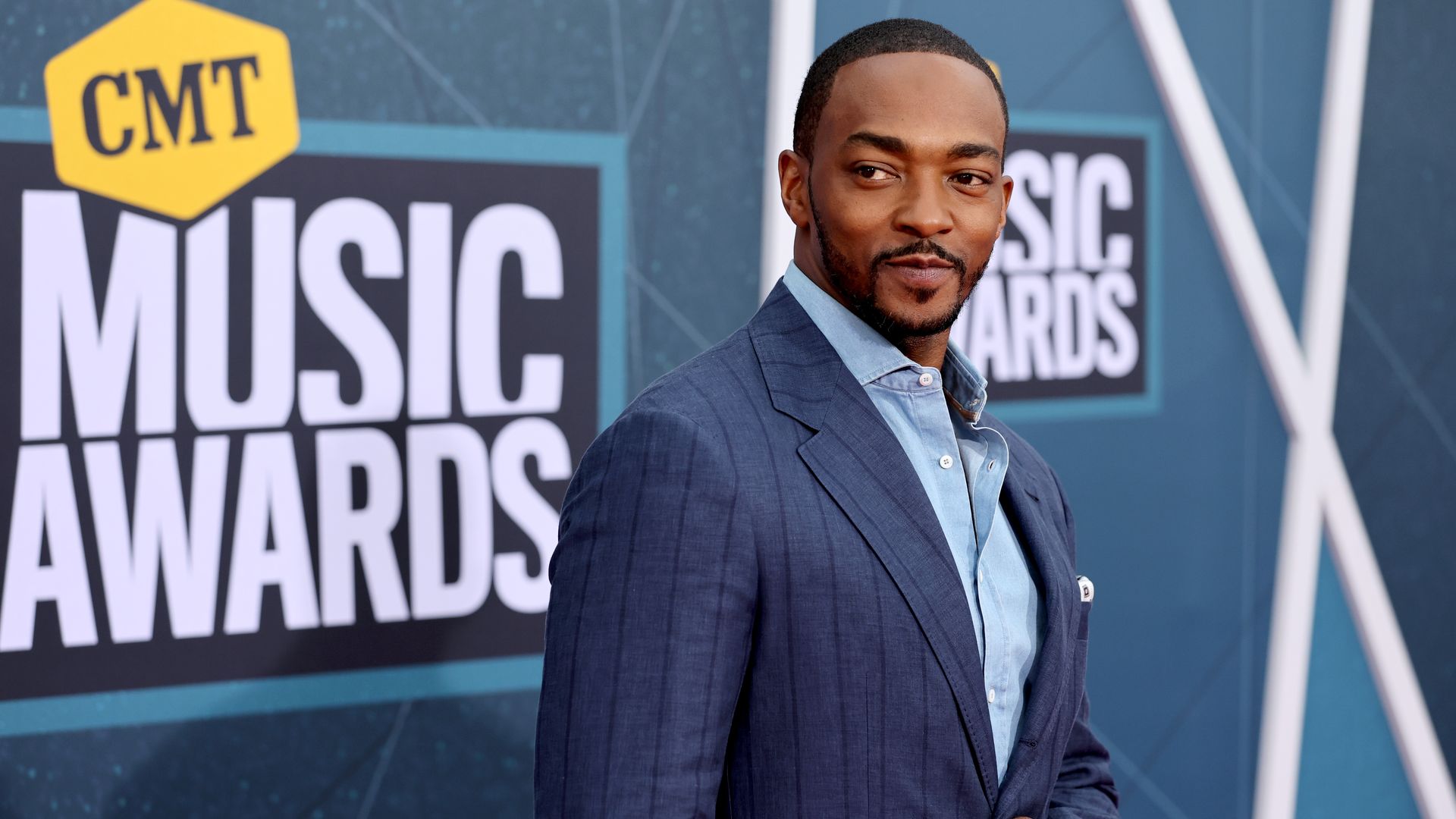 Anthony Mackie poses for a photo on a CMT Music Awards red carpet.