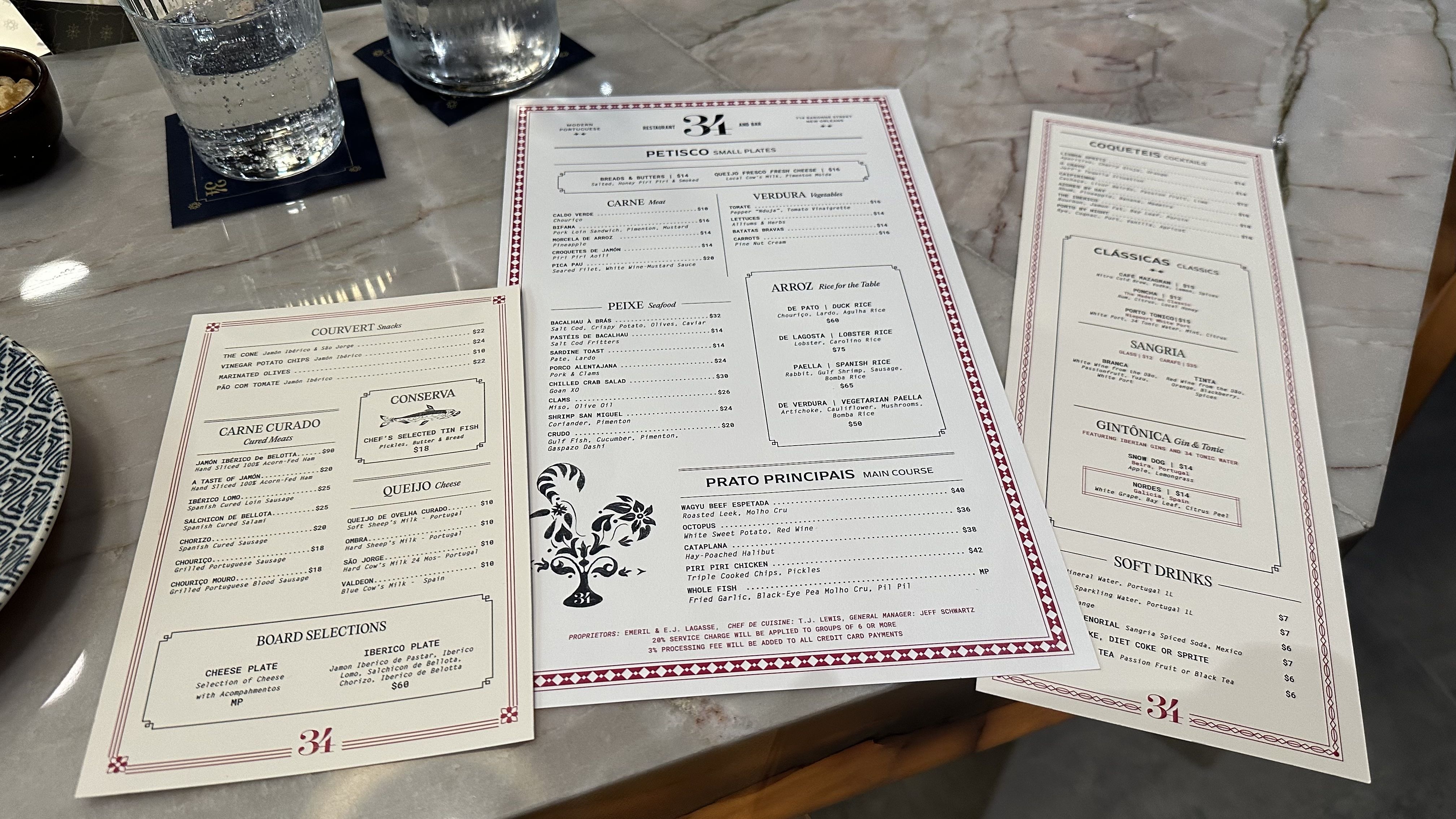 Three menus sit on a marble countertop.