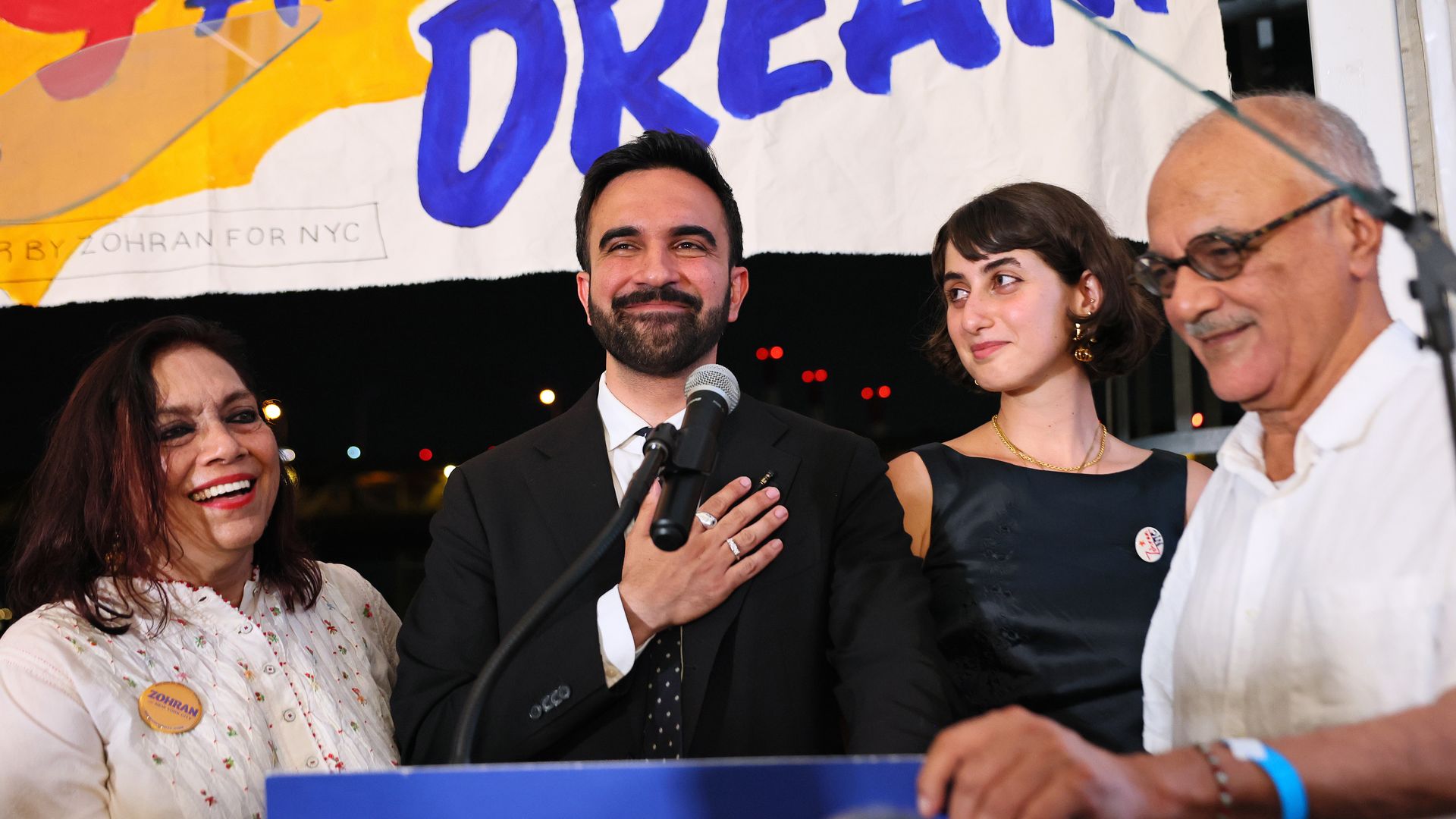 zohran mamdani on stage with his wife and parents