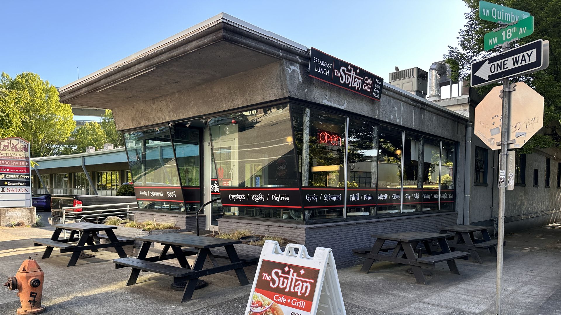 A photo of a building with the words "The Sultan Cafe" written on a placard. 