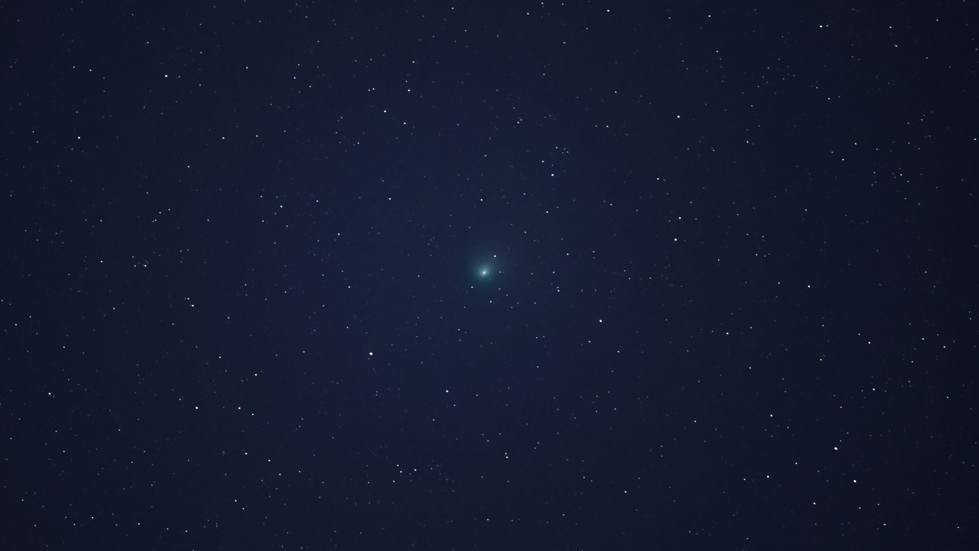 Green comet amongst stars