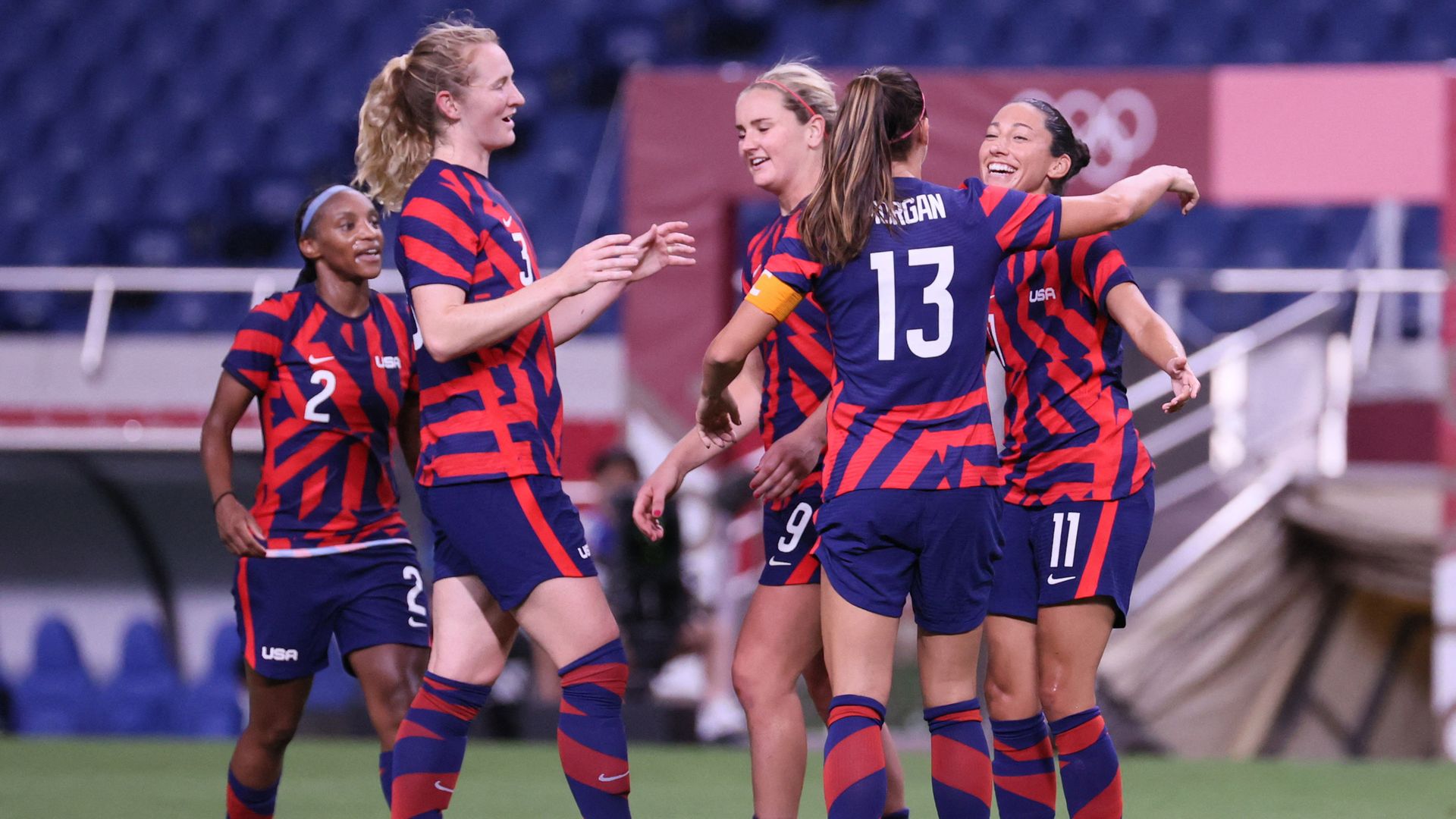 USA's forward Christen Press (R) celebrates her goal with teammates during the Tokyo 2020 Olympic Games 