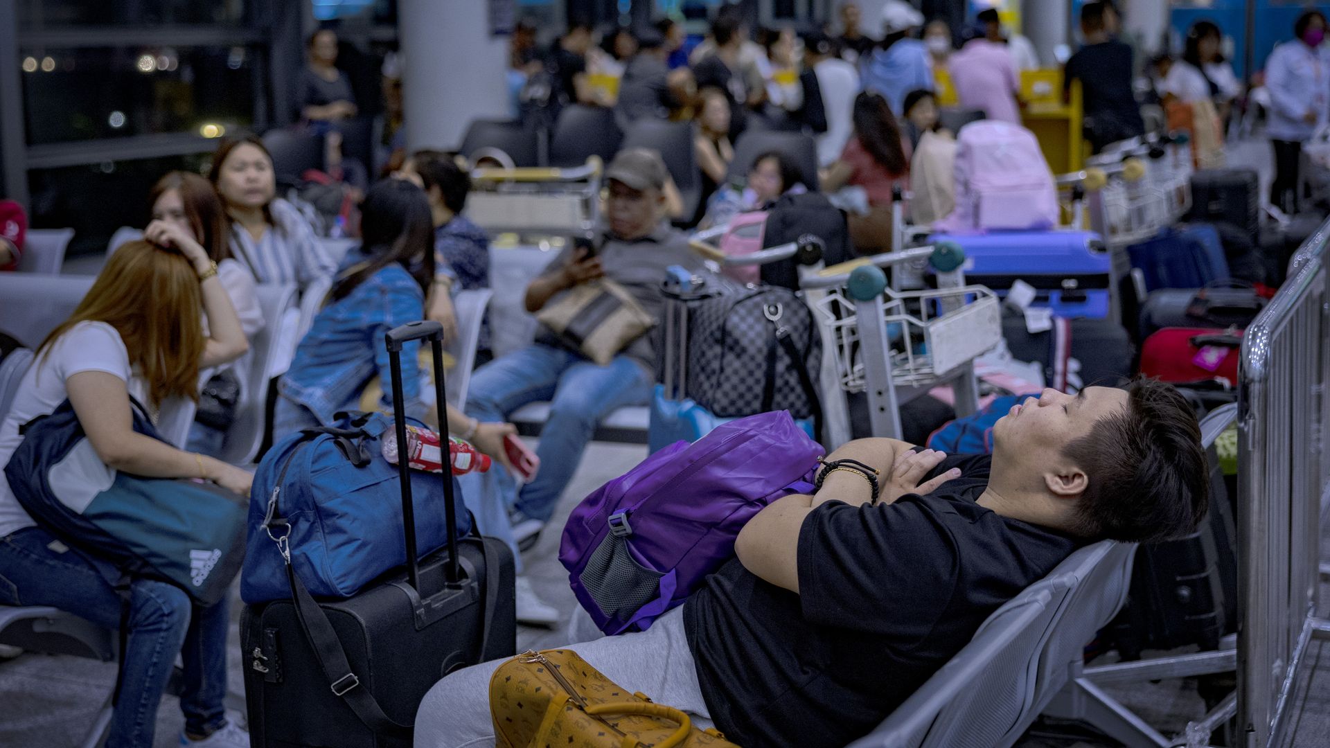 Passengers wait for check-in counters to open at Ninoy Aquino International Airport, amid a global IT disruption caused by a Microsoft outage and a Crowdstrike IT problem, on July 19, 2024 in Manila, Philippines. A significant global outage affecting Microsoft services, particularly Microsoft 365, h