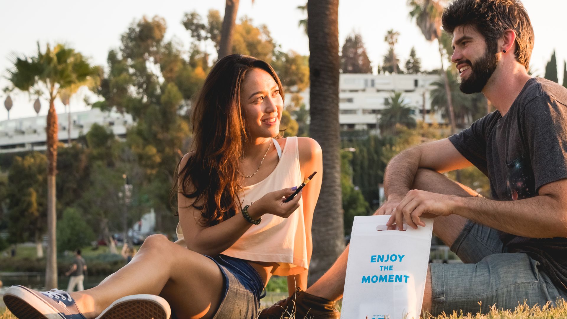 A man and a woman enjoying a delivery from Eaze
