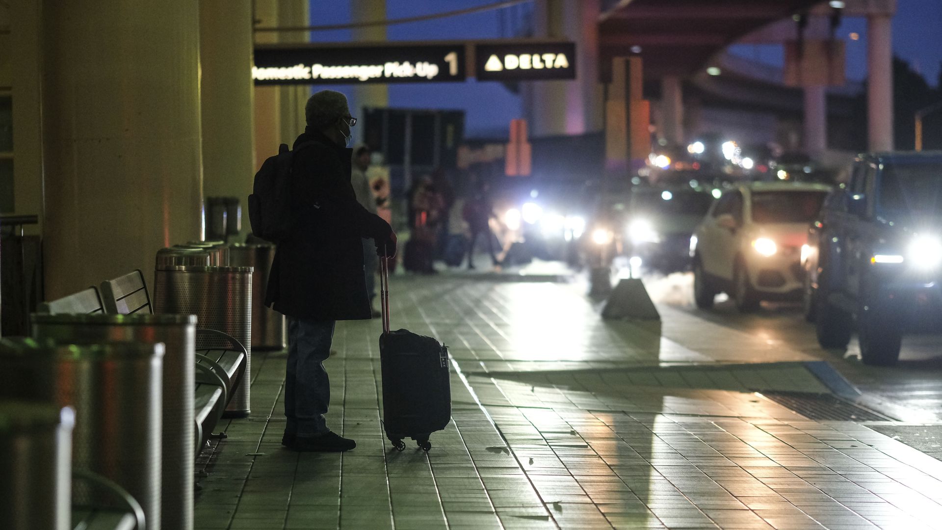 A traveler stands outside Detroit Metro Airport.